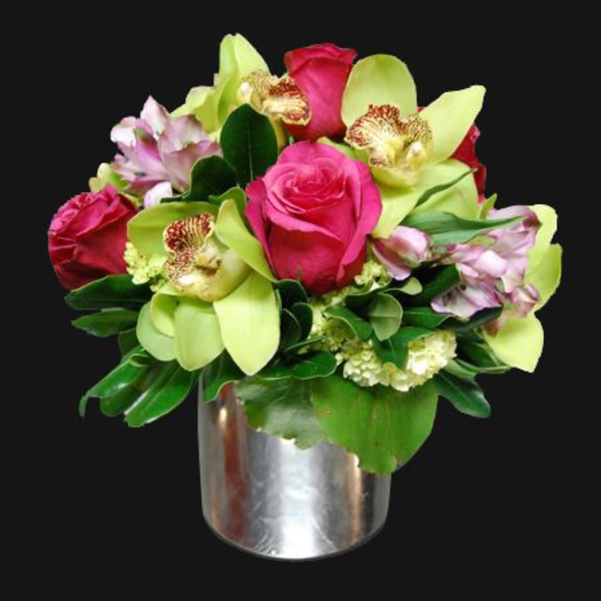 Pink roses and green orchids arranged in a silver vase
