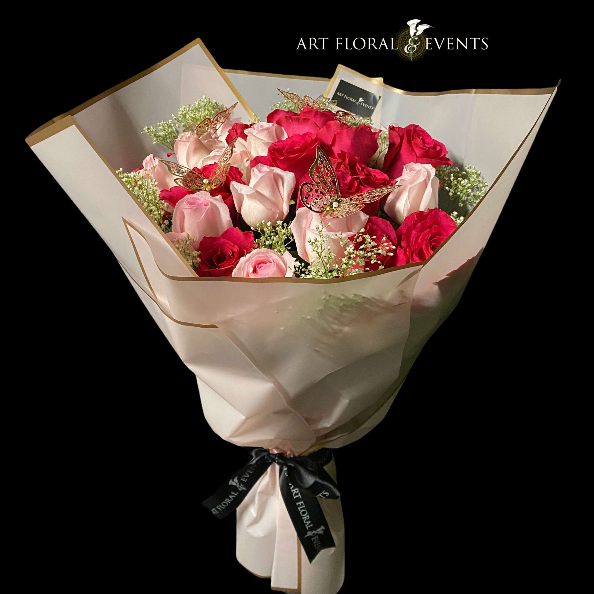 Bouquet of pink and red roses wrapped in cream paper