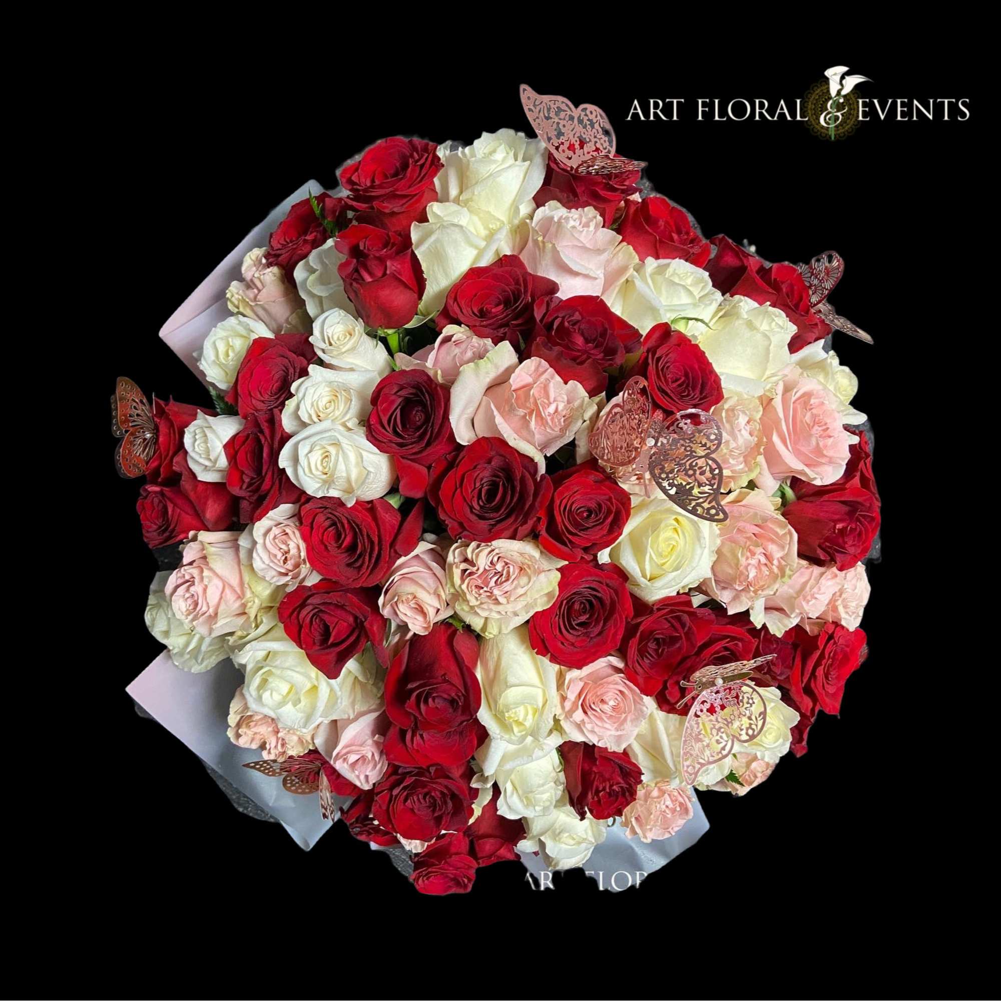 Bouquet of red, white, and blush roses with butterfly accents