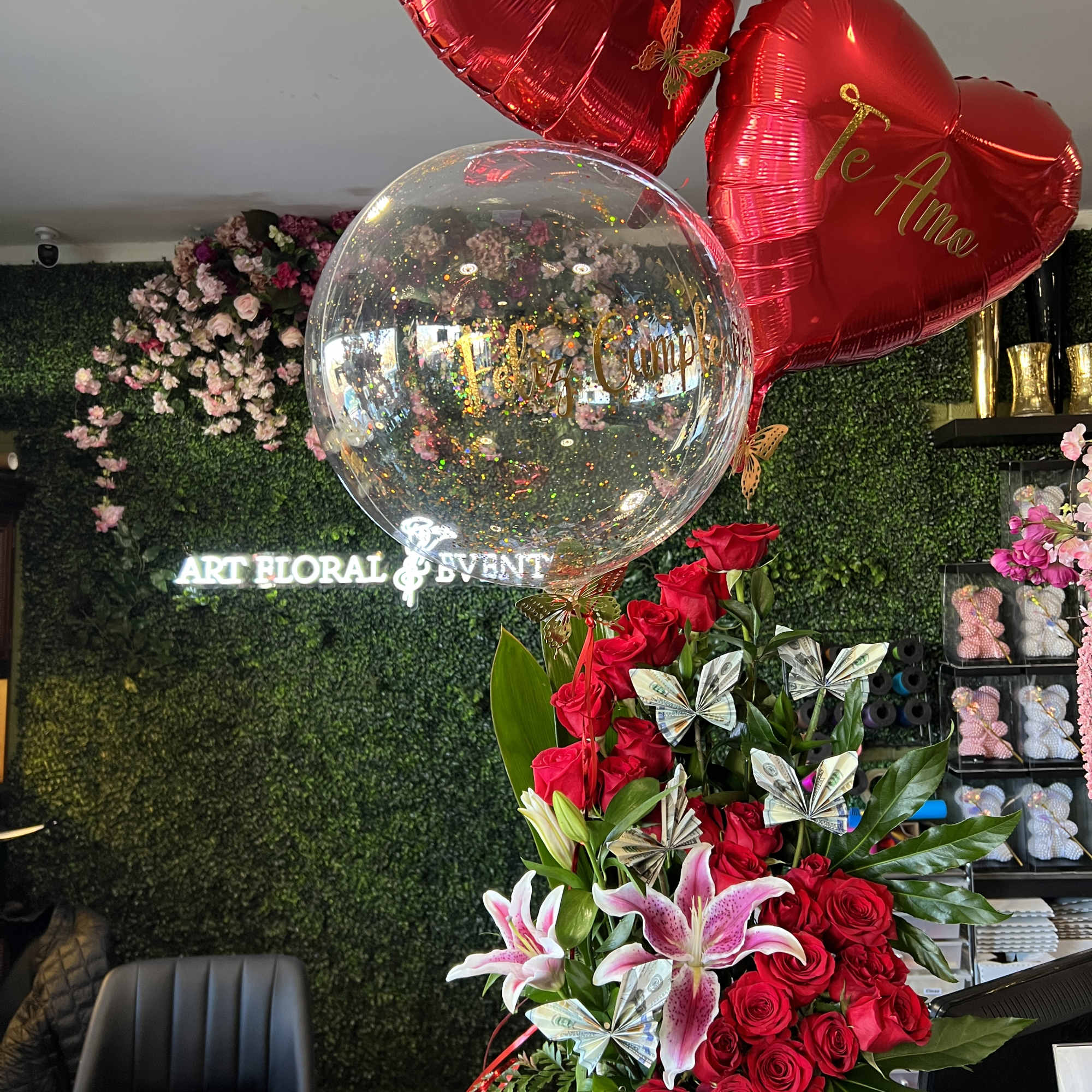 Red rose and lily arrangement with heart balloons and a clear balloon