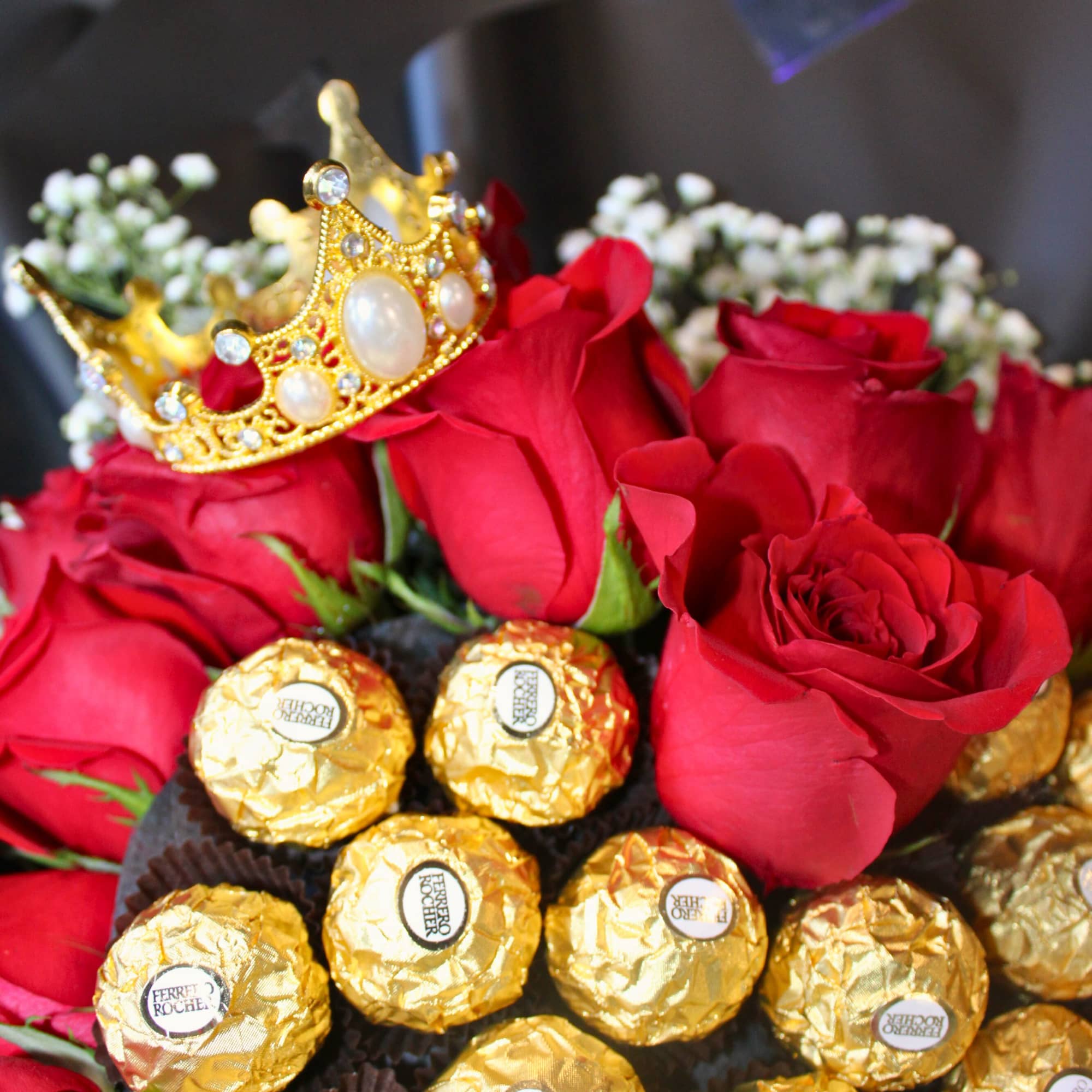 Red roses with Ferrero Rocher chocolates and a gold crown topper