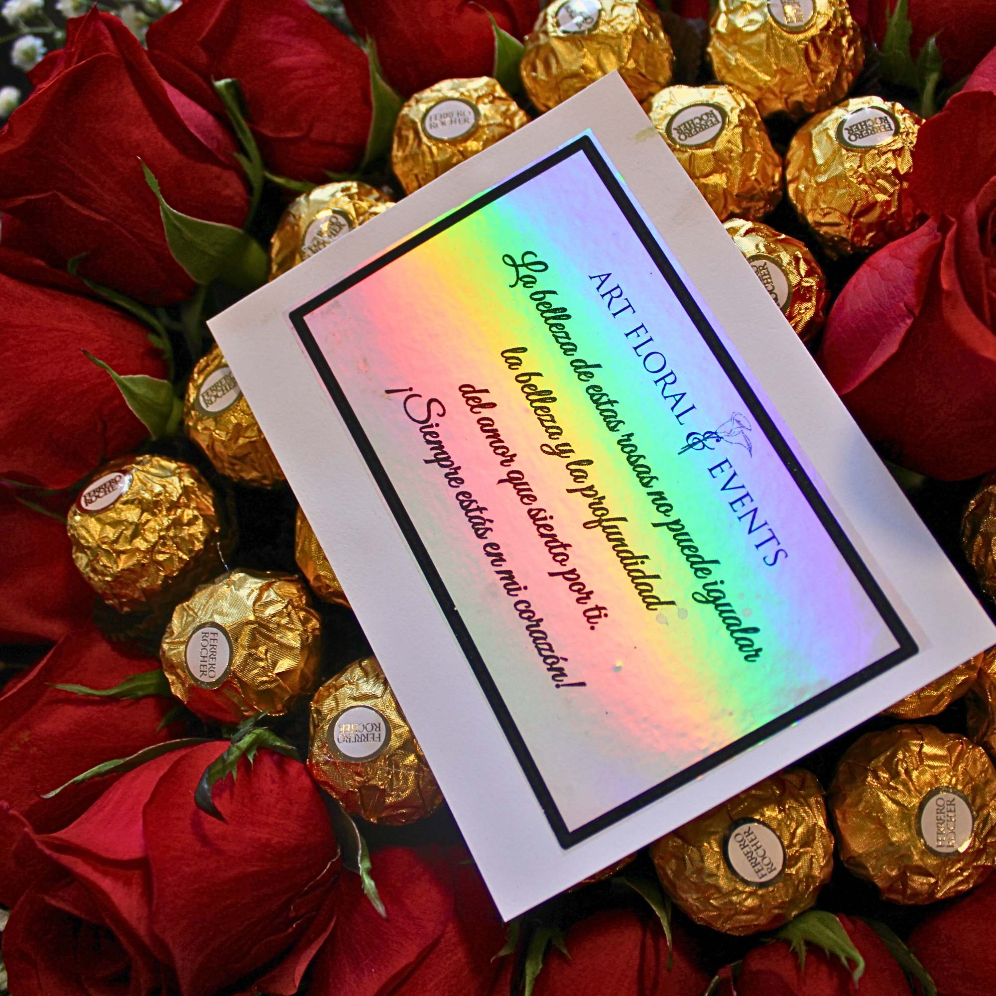 Red rose bouquet with gold-wrapped chocolates and a greeting card