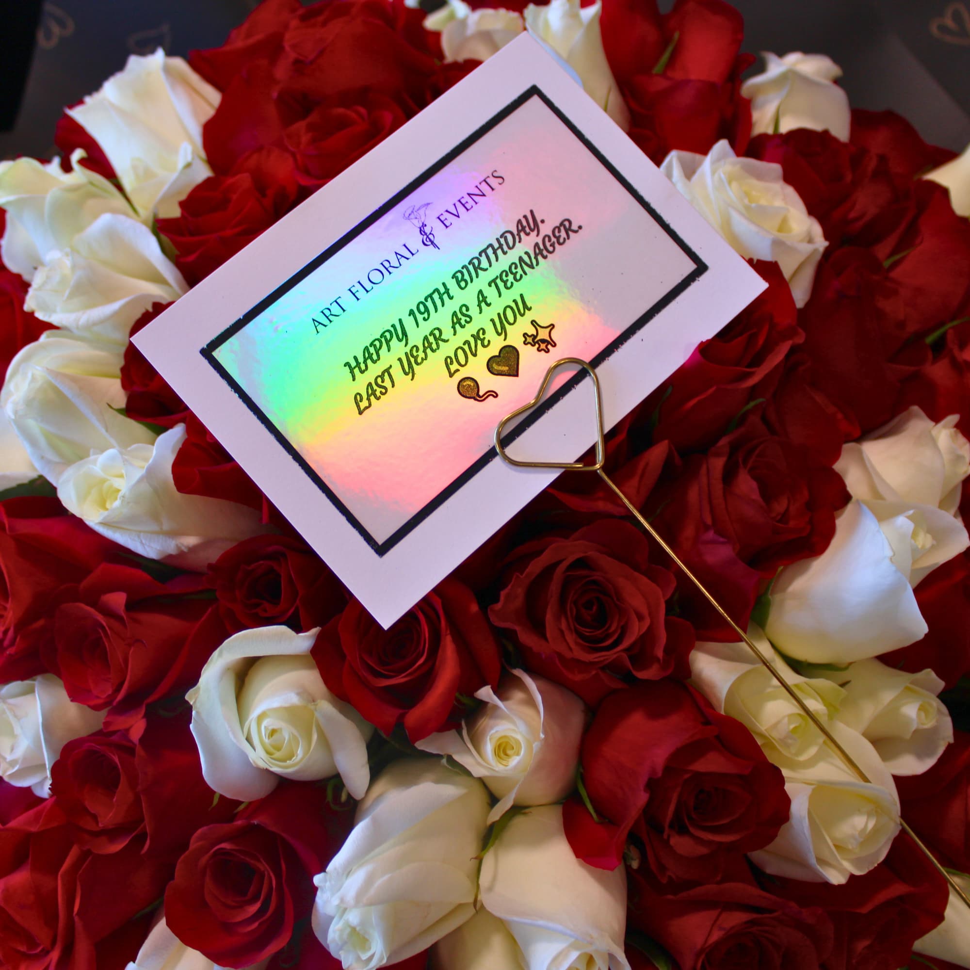 Bouquet of red and white roses with a birthday card