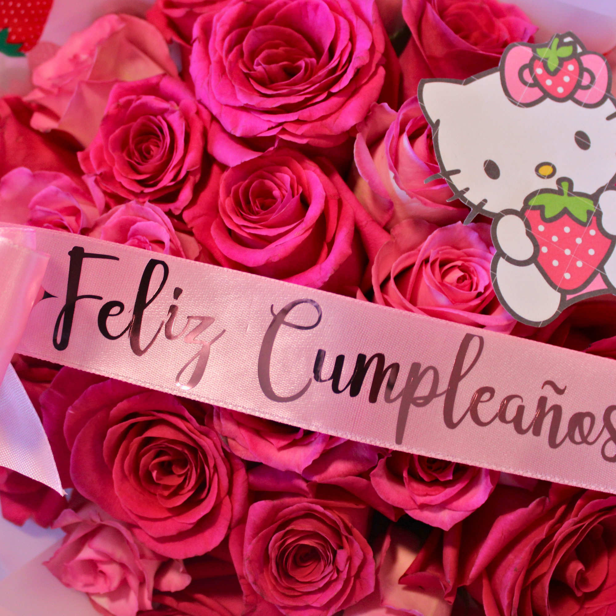 Pink rose bouquet with a Hello Kitty topper and birthday ribbon