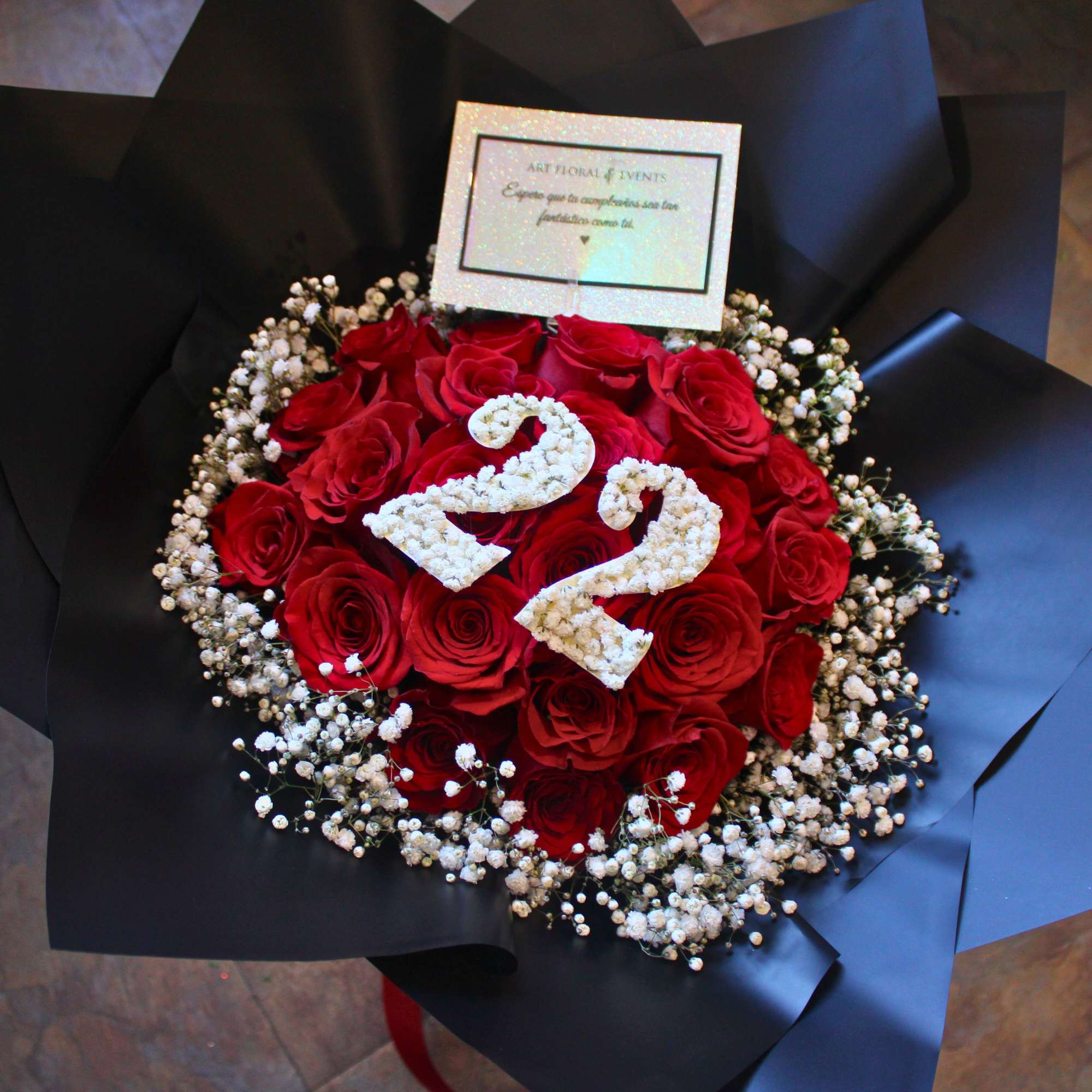 Red rose bouquet with white floral number 22 and black wrapping