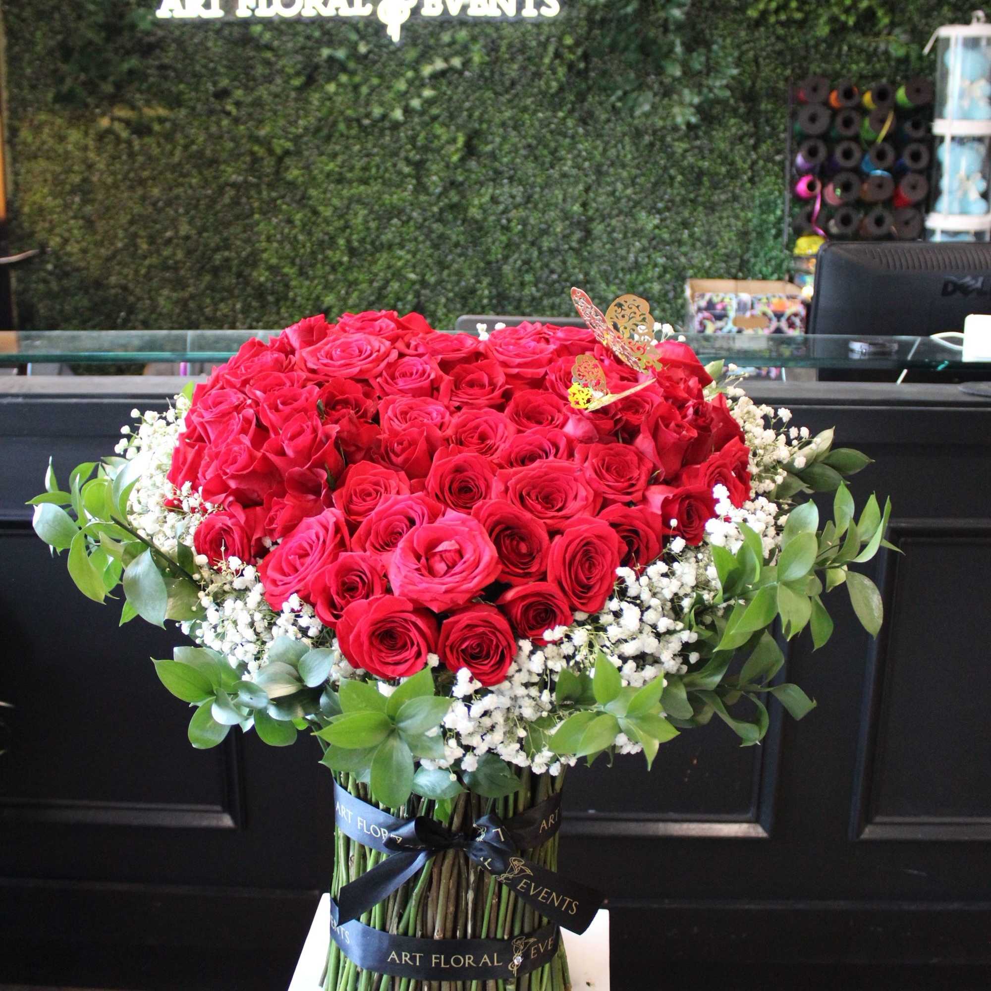 Large bouquet of red roses with white baby's breath and greenery