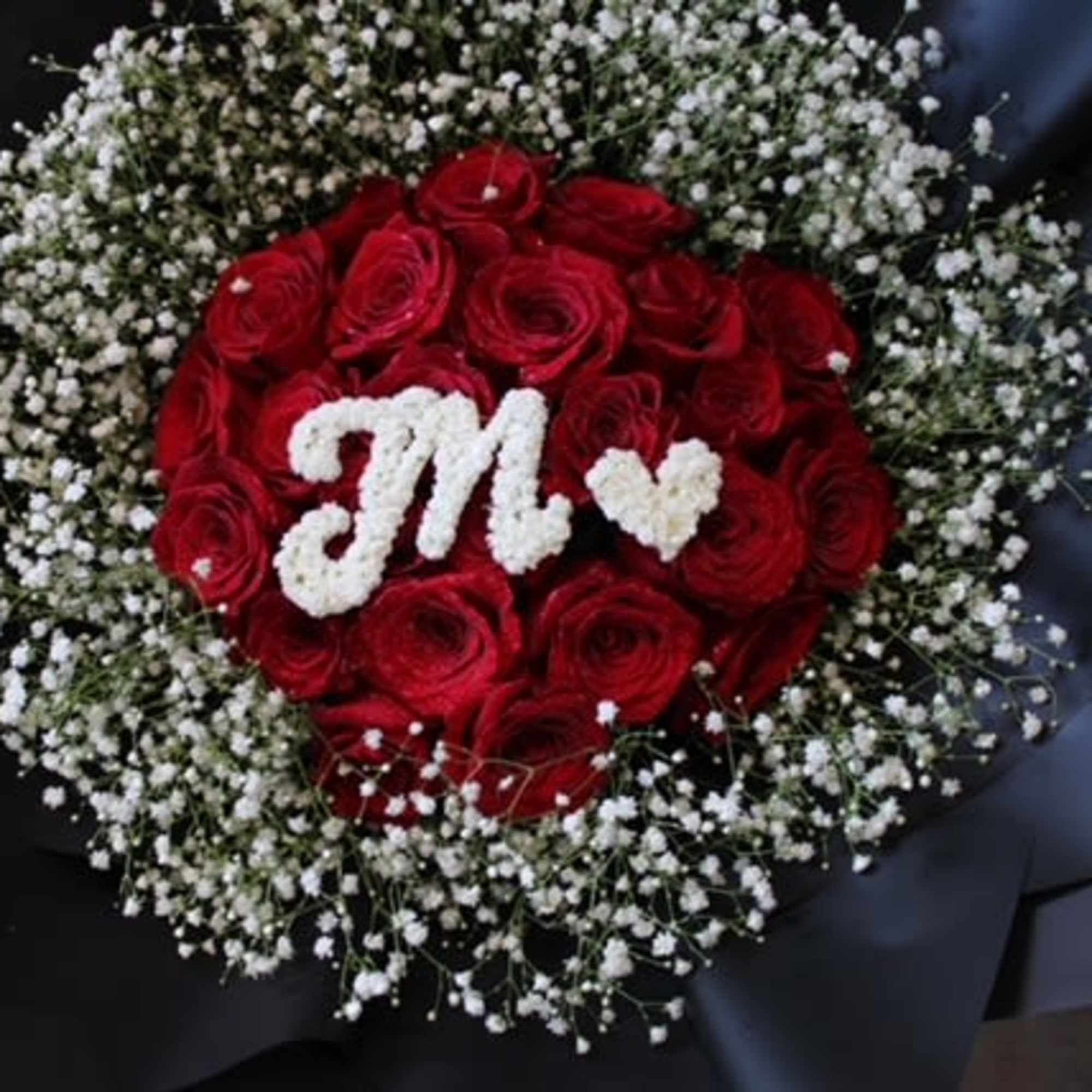 Red rose bouquet with white baby's breath and a white floral monogram