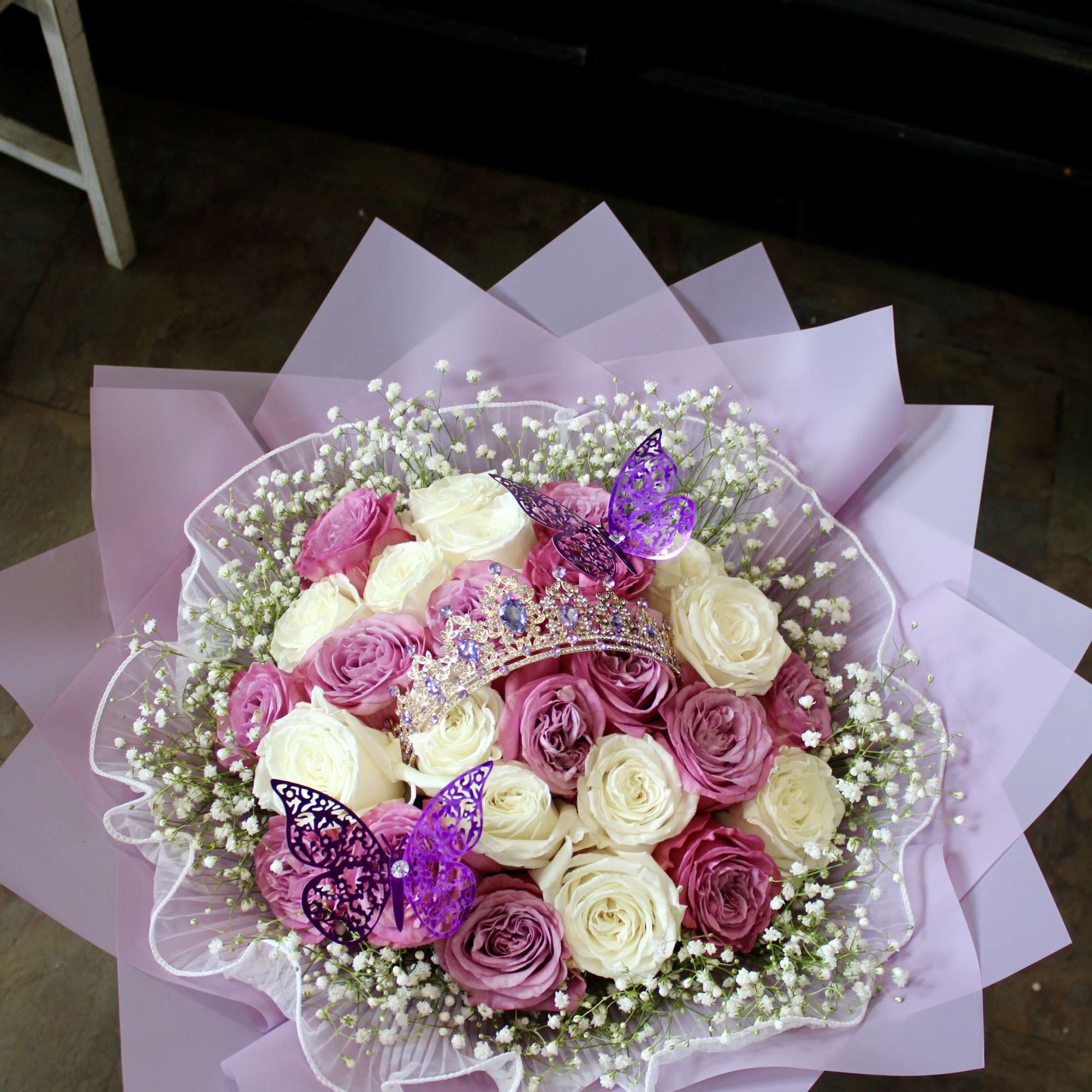 Pink and white rose bouquet with baby’s breath and butterfly toppers