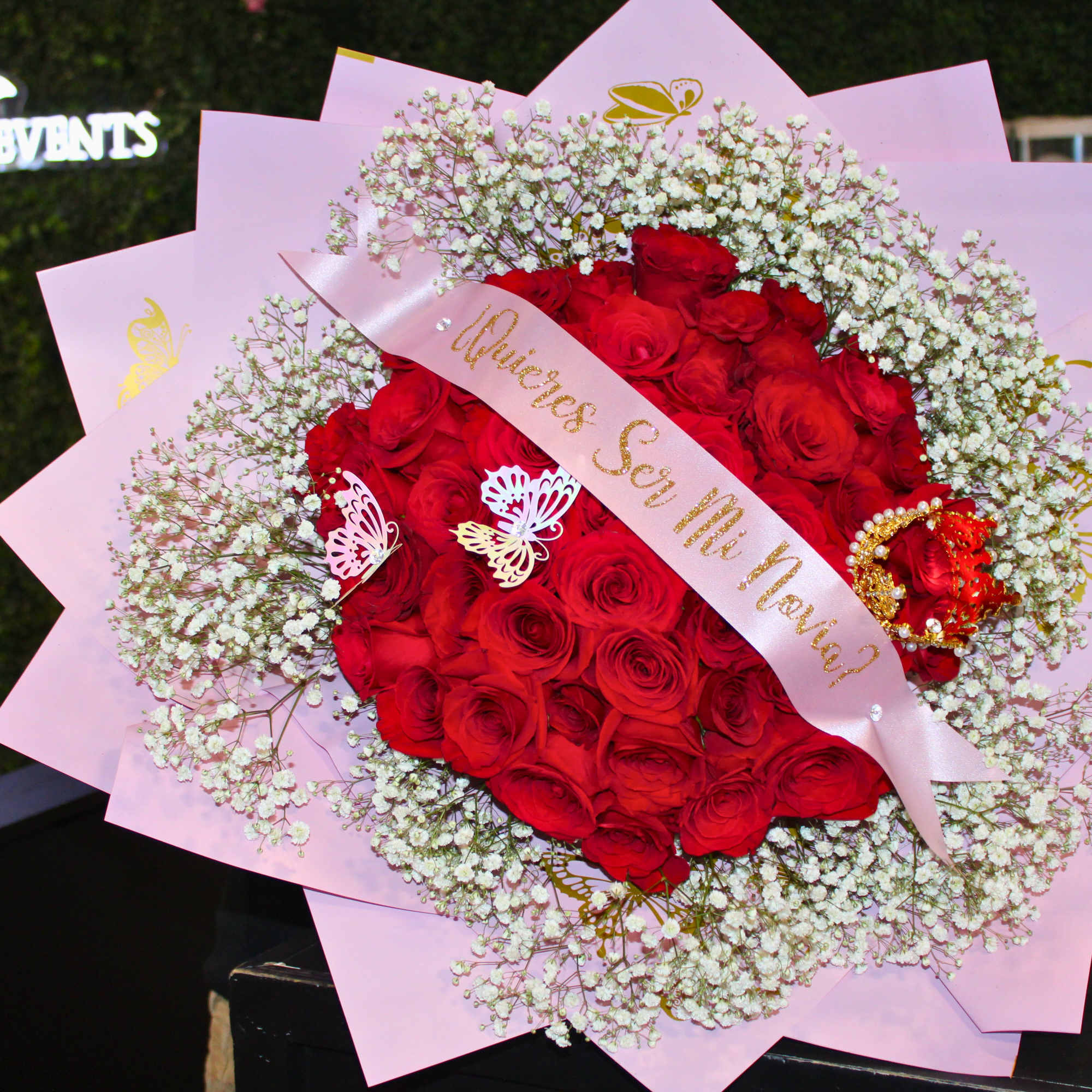 Large bouquet of red roses with white baby's breath in pink wrapping
