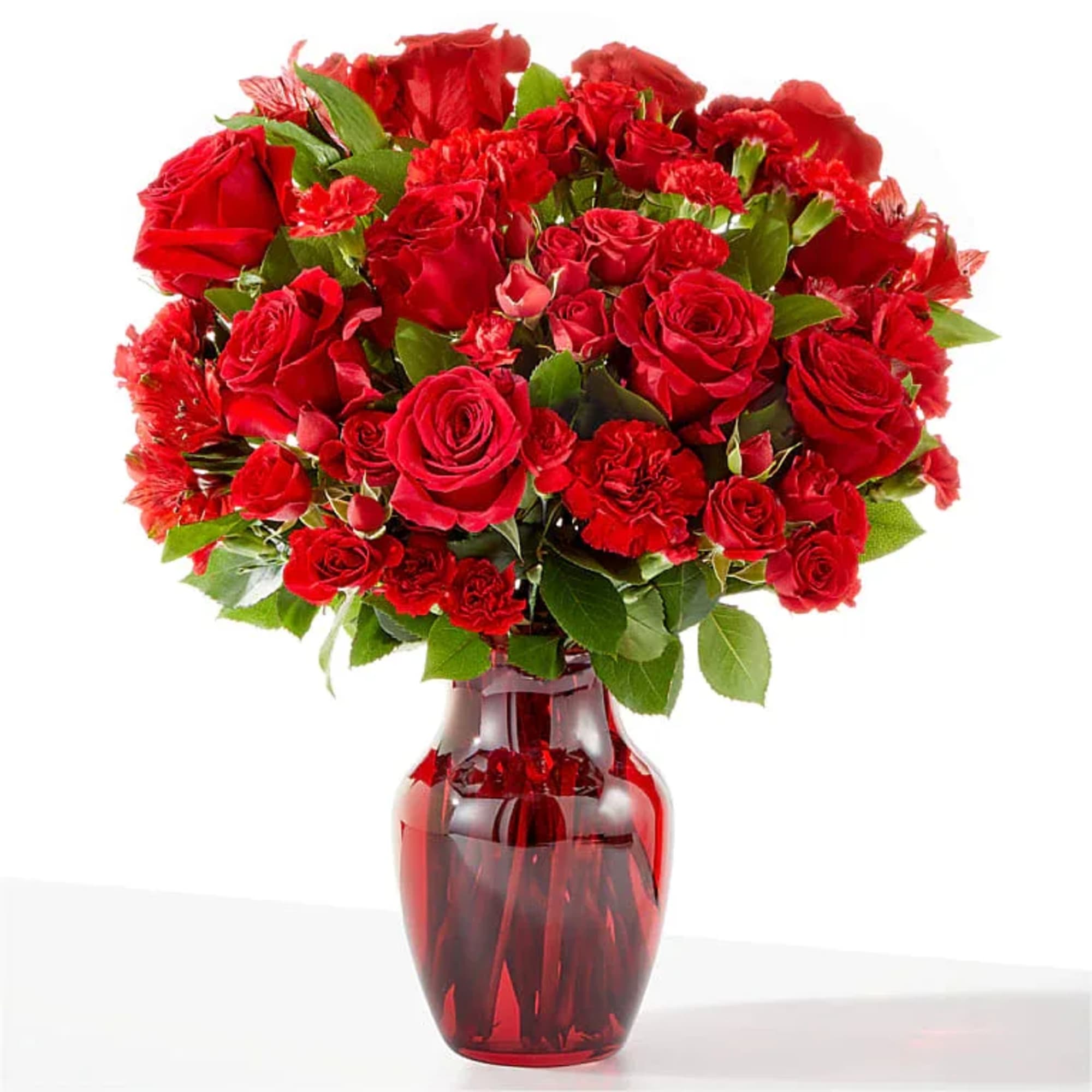 Red roses and carnations in a red glass vase