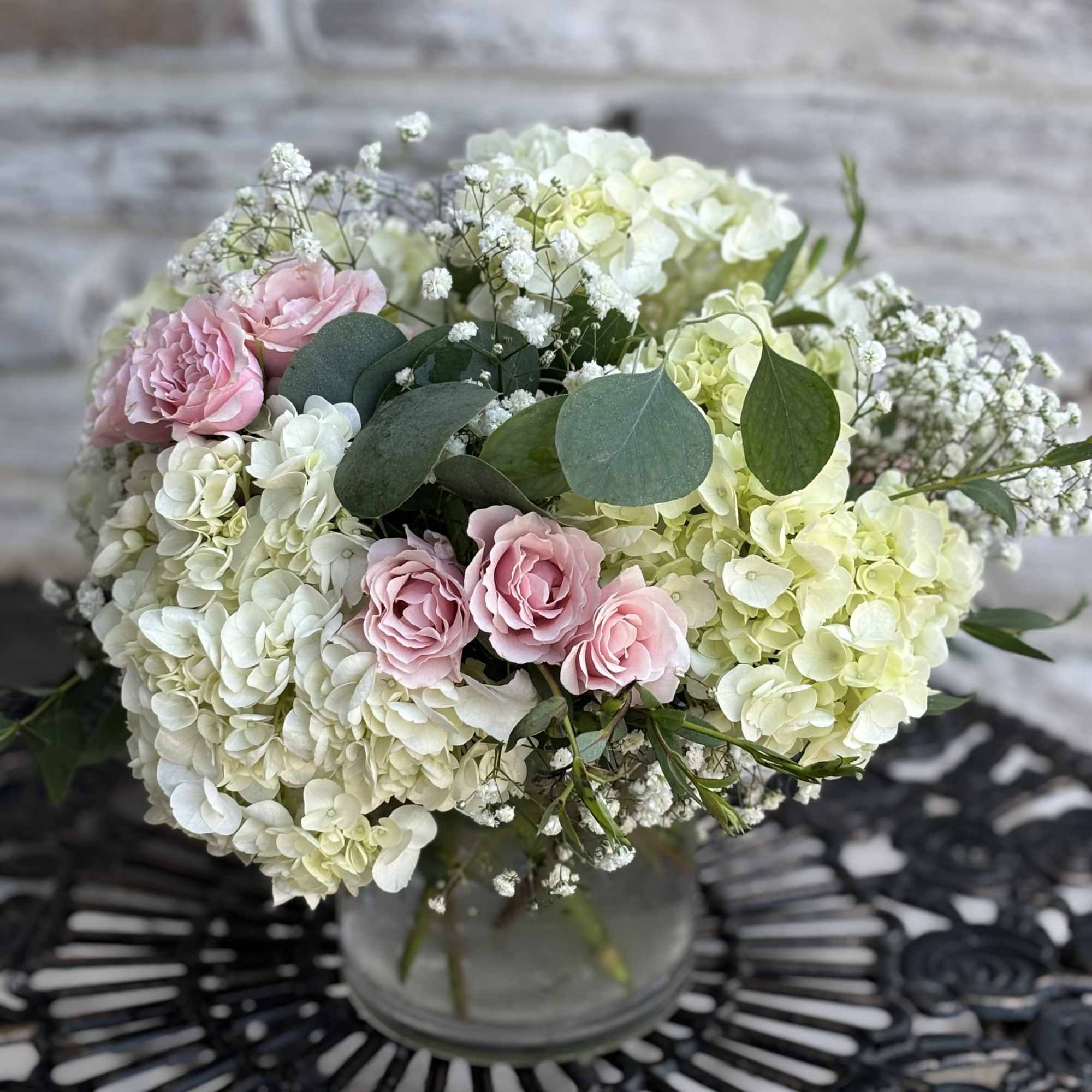 Pink roses and white hydrangeas in a glass vase