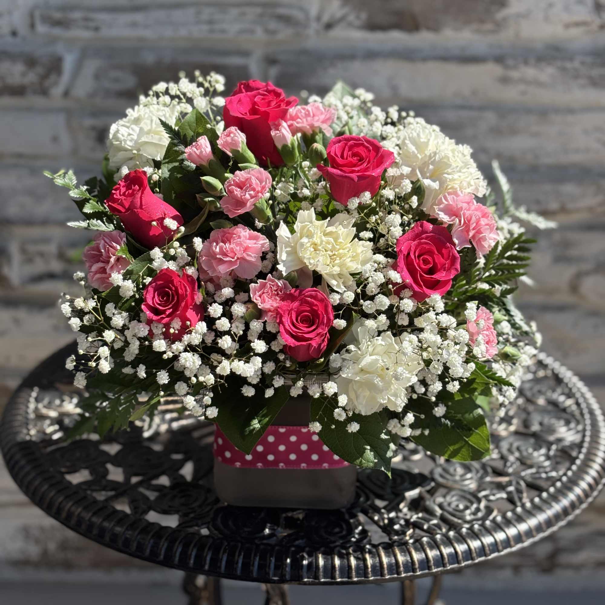 This beautiful bouquet features pink roses with pink and white carnations arranged