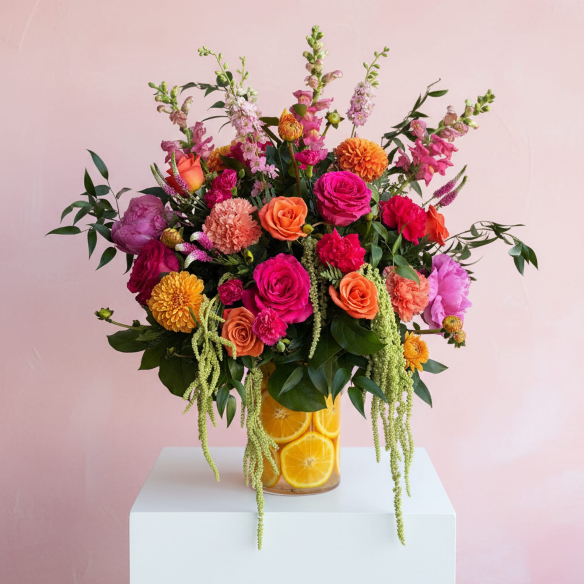 Gorgeous mix of pinks and orange flowers beautifully arranged, sits on a