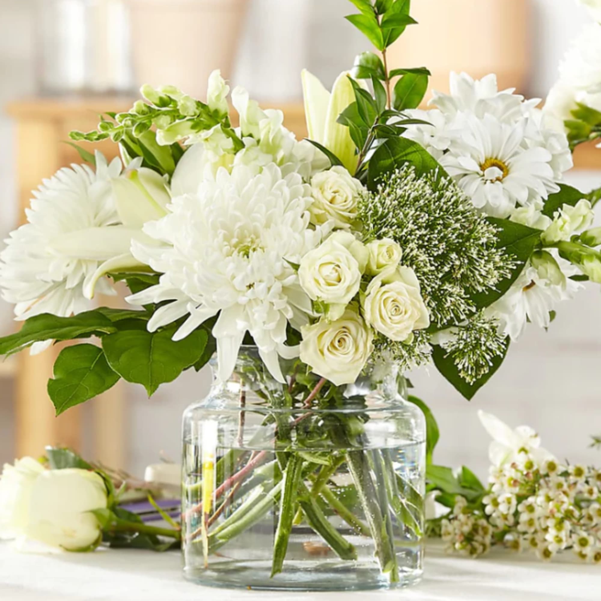 White flowers arranged in a clear glass vase
