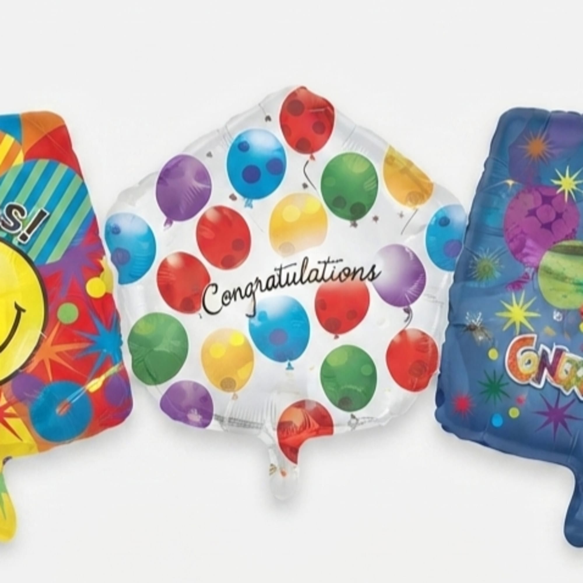 Three square congratulatory balloons with colorful patterns and text