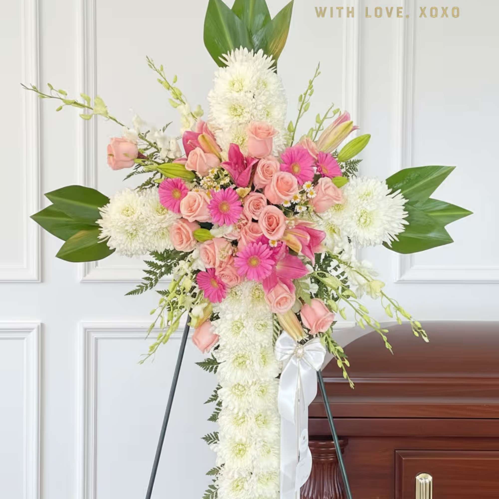Standing floral spray with pink roses and white chrysanthemums on an easel