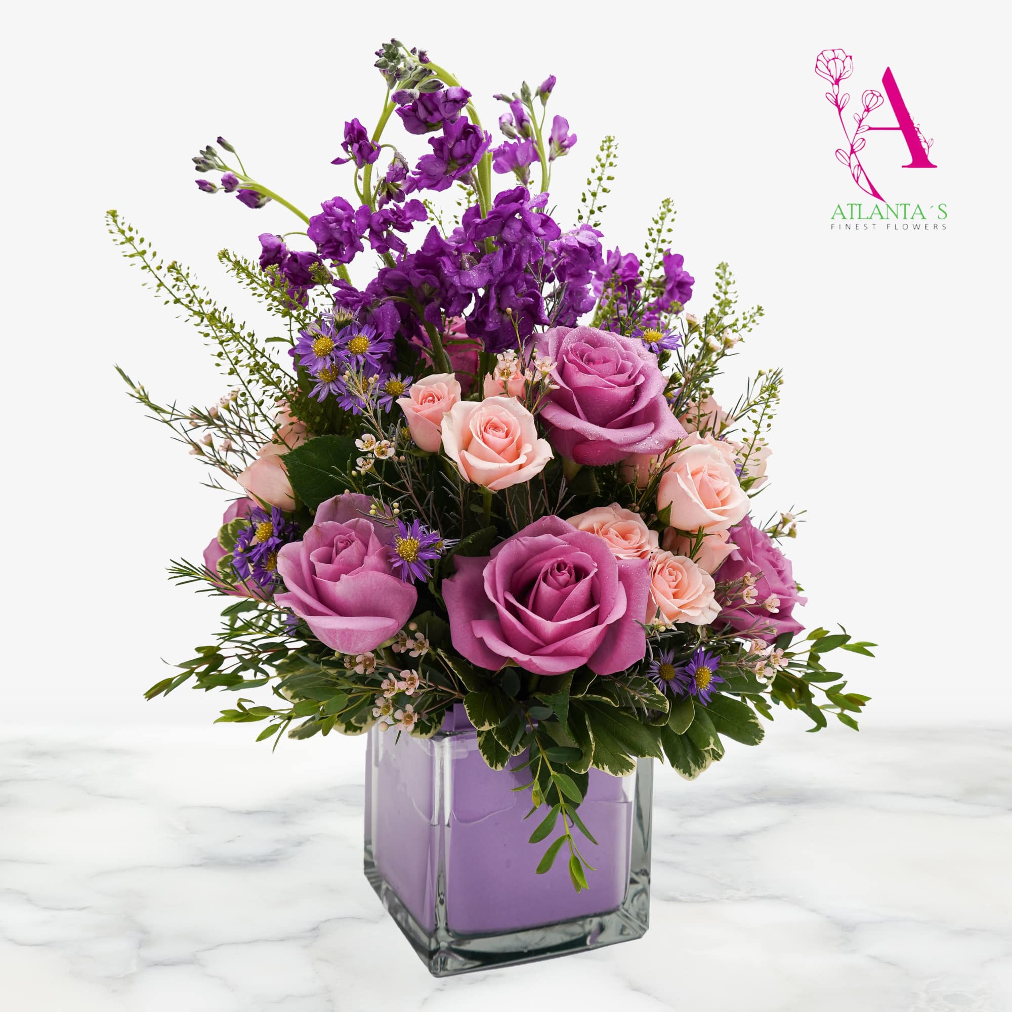 A lush mix of large lavender roses, blush pink spray roses, and, photo 2 of 2