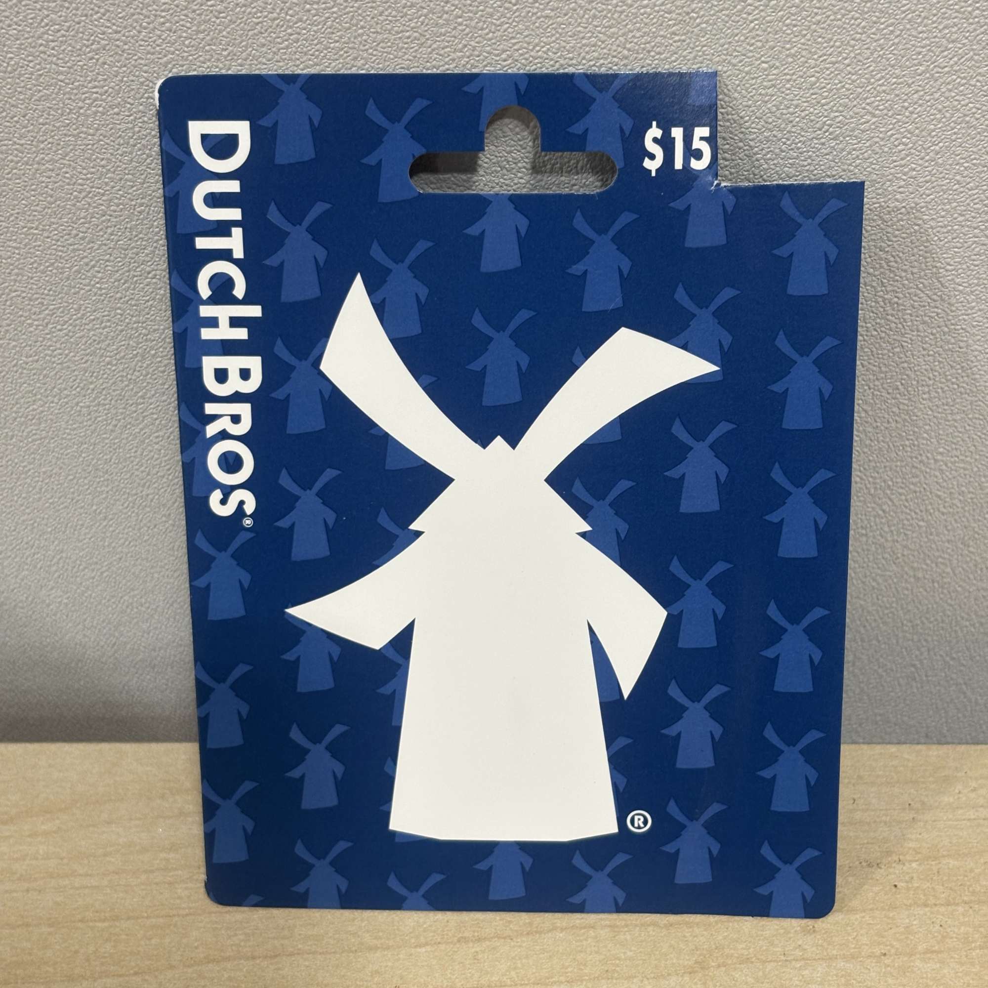 Dutch Bros gift card in blue packaging with a white windmill logo