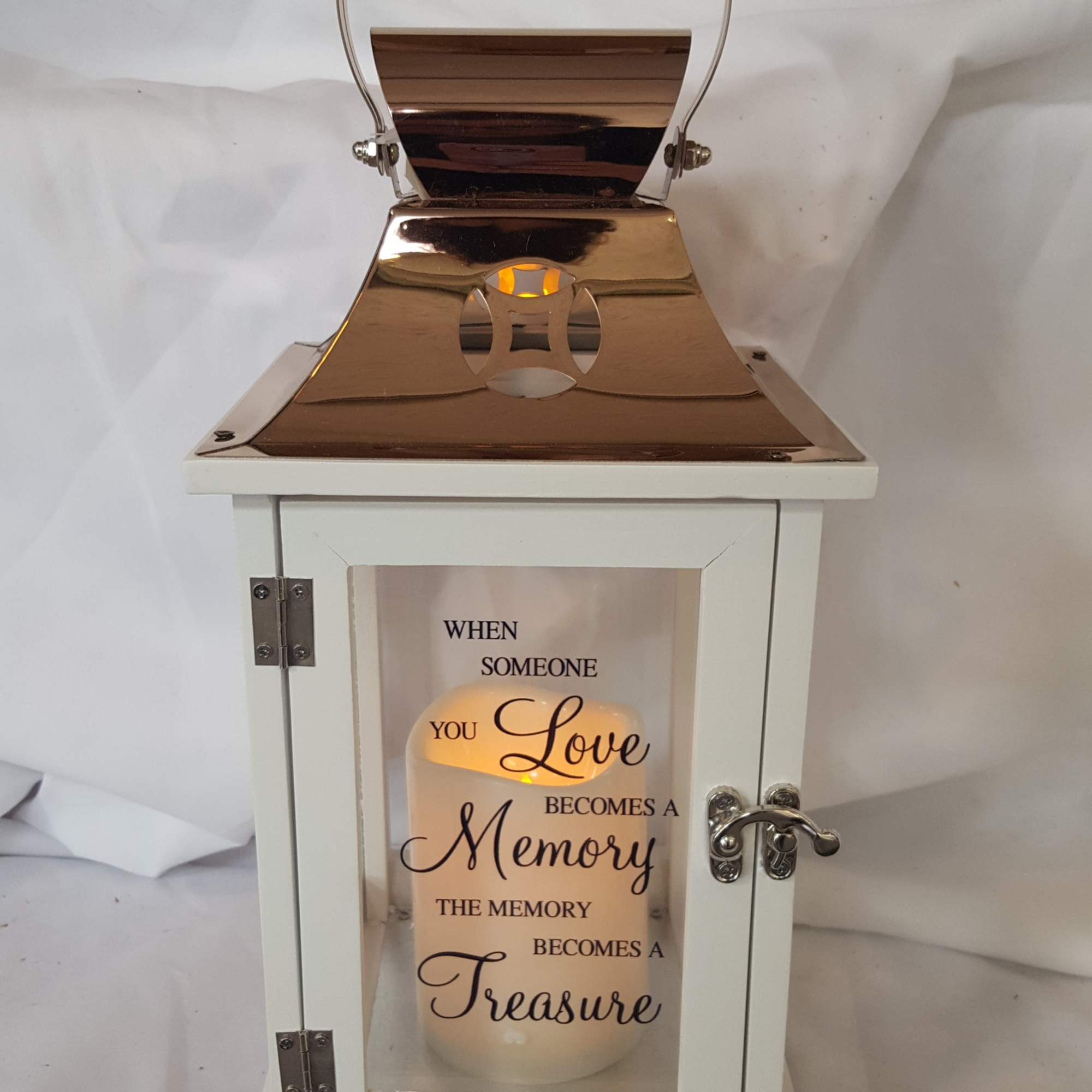 White memorial lantern with a candle and printed quote