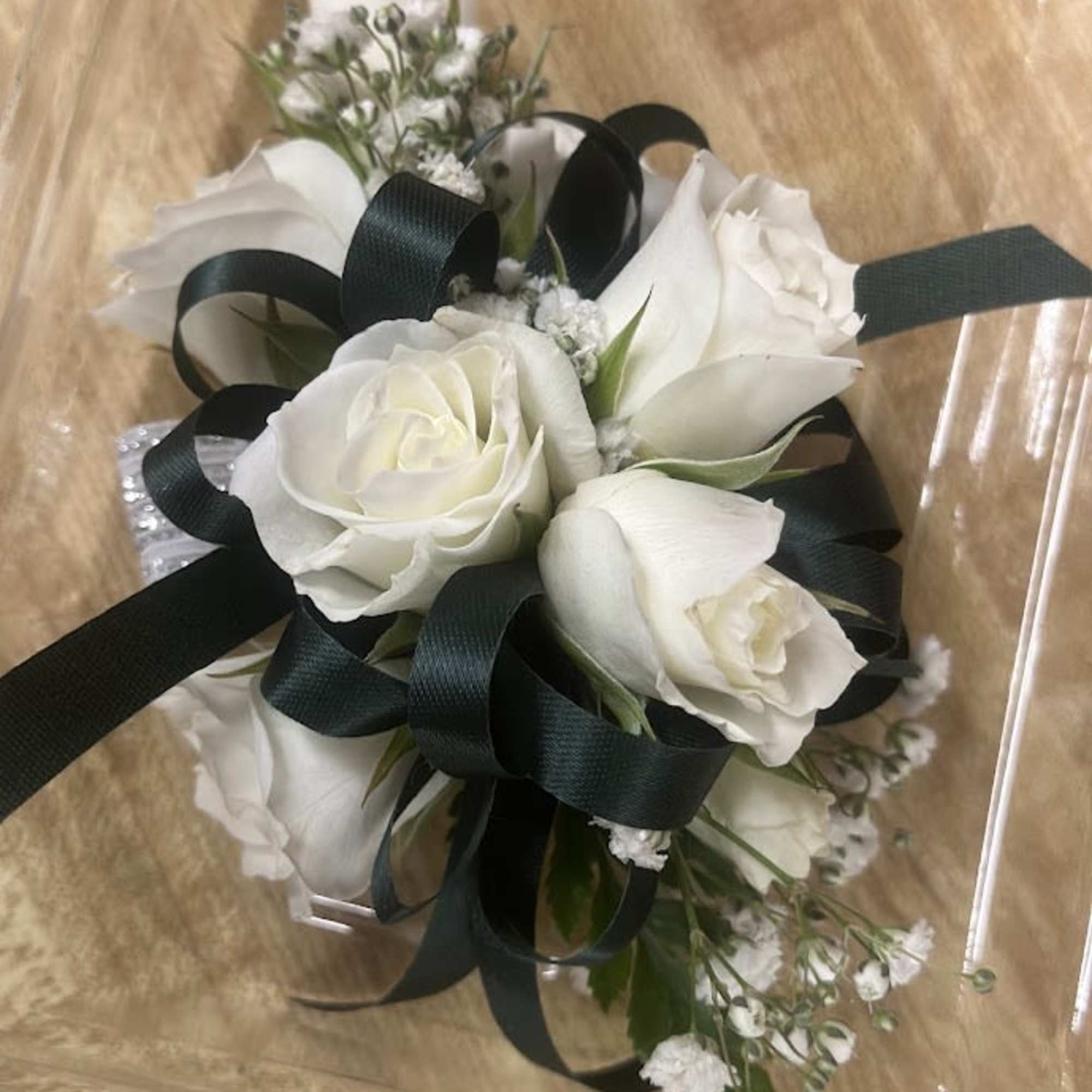 A delicate white rose corsage and matching boutonniere set that reads as, photo 2 of 4