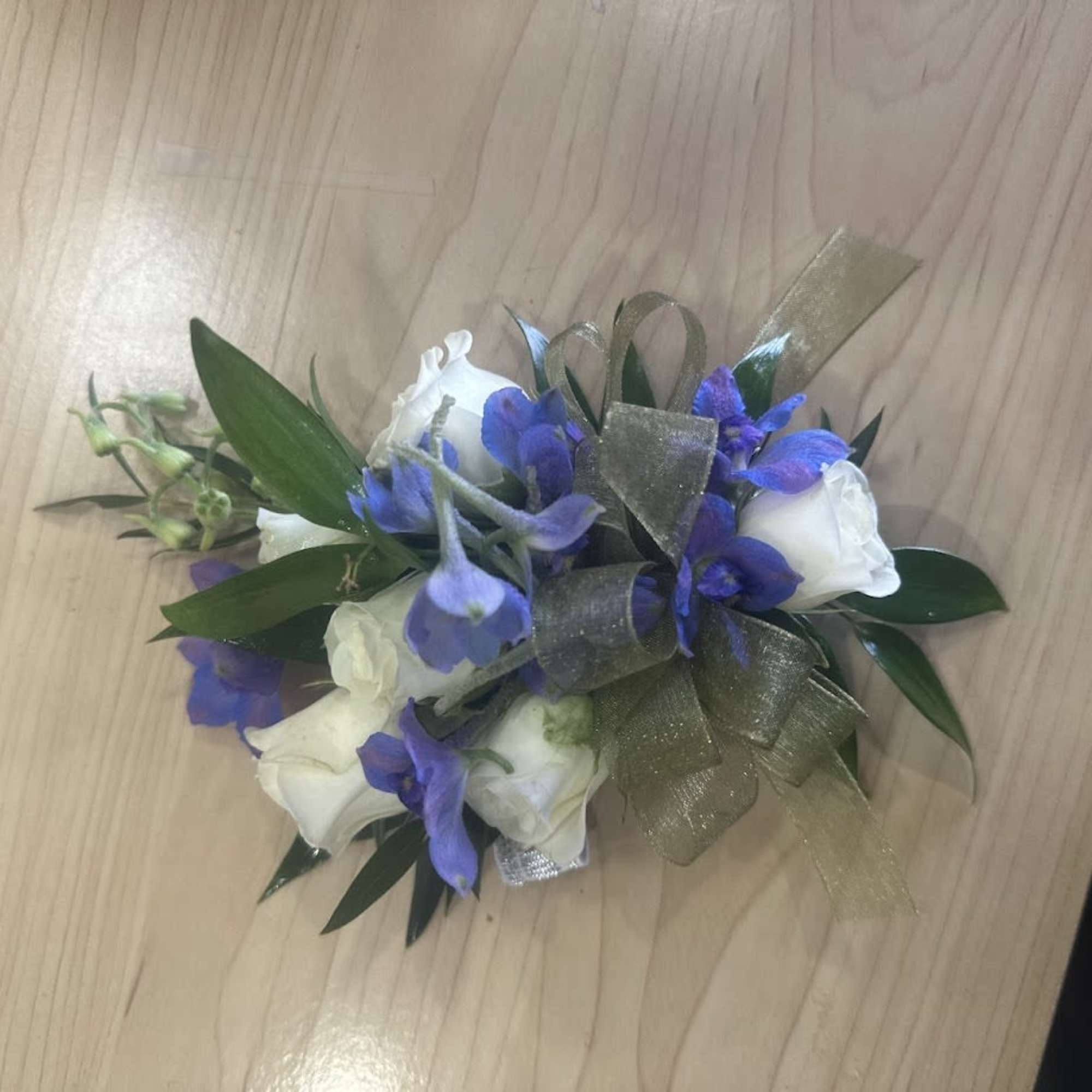 A delicate white rose corsage and matching boutonniere set that reads as, photo 2 of 4