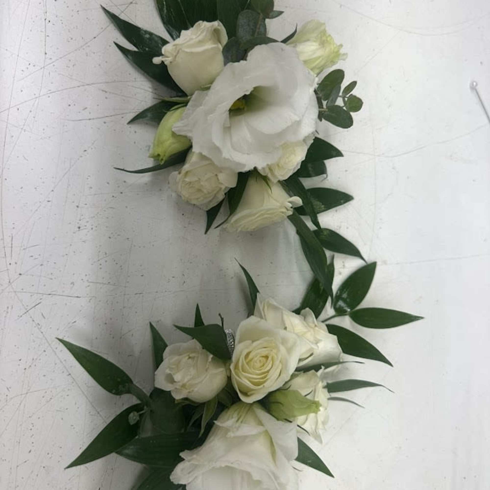 A delicate white rose corsage and matching boutonniere set that reads as, photo 4 of 4