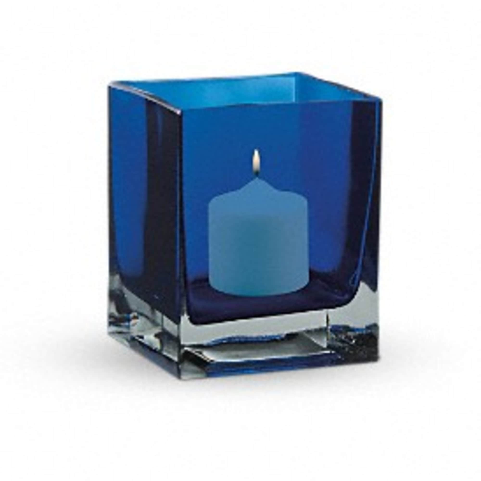 Blue candle in a square glass holder