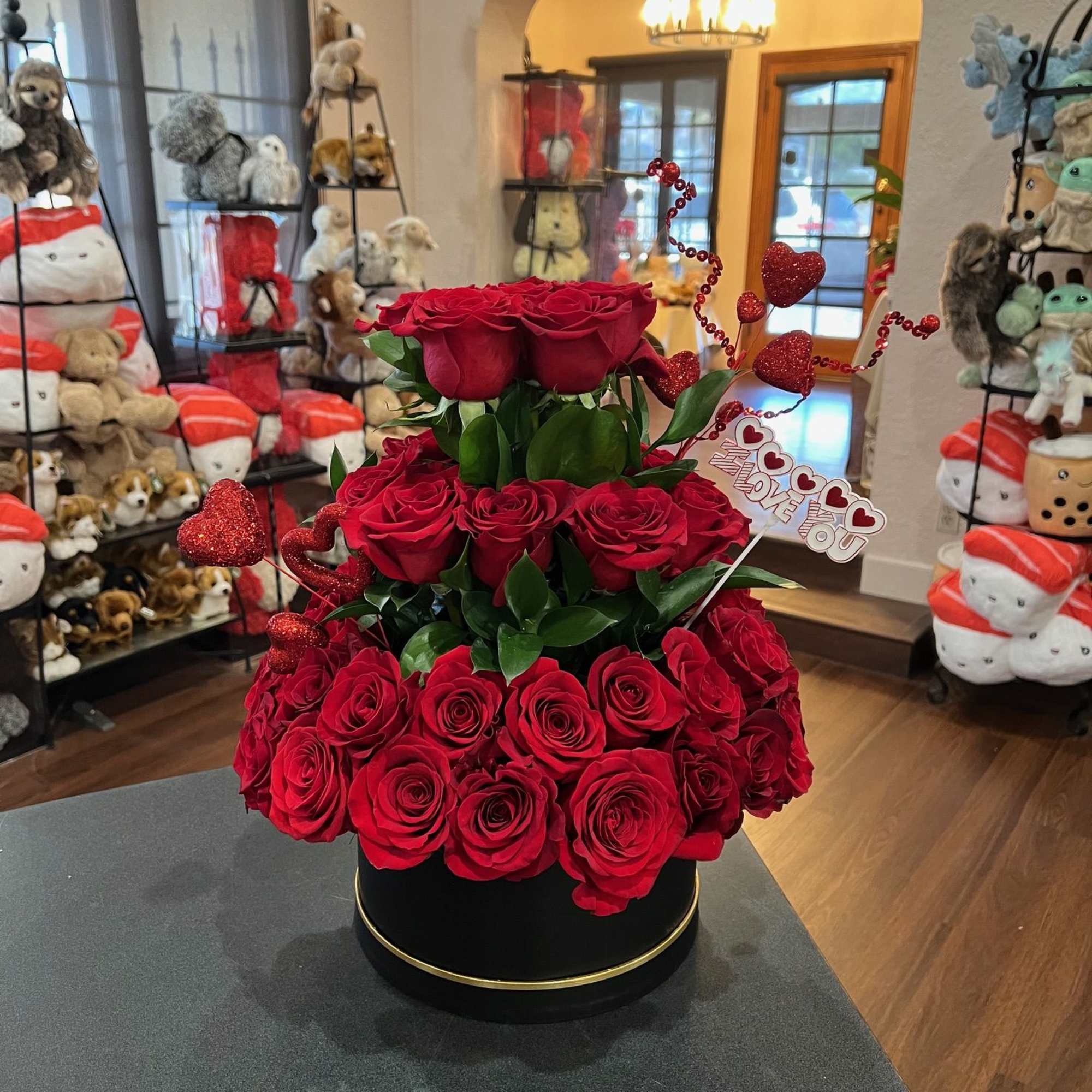 3 tiers of roses arranged inside a round flower box.