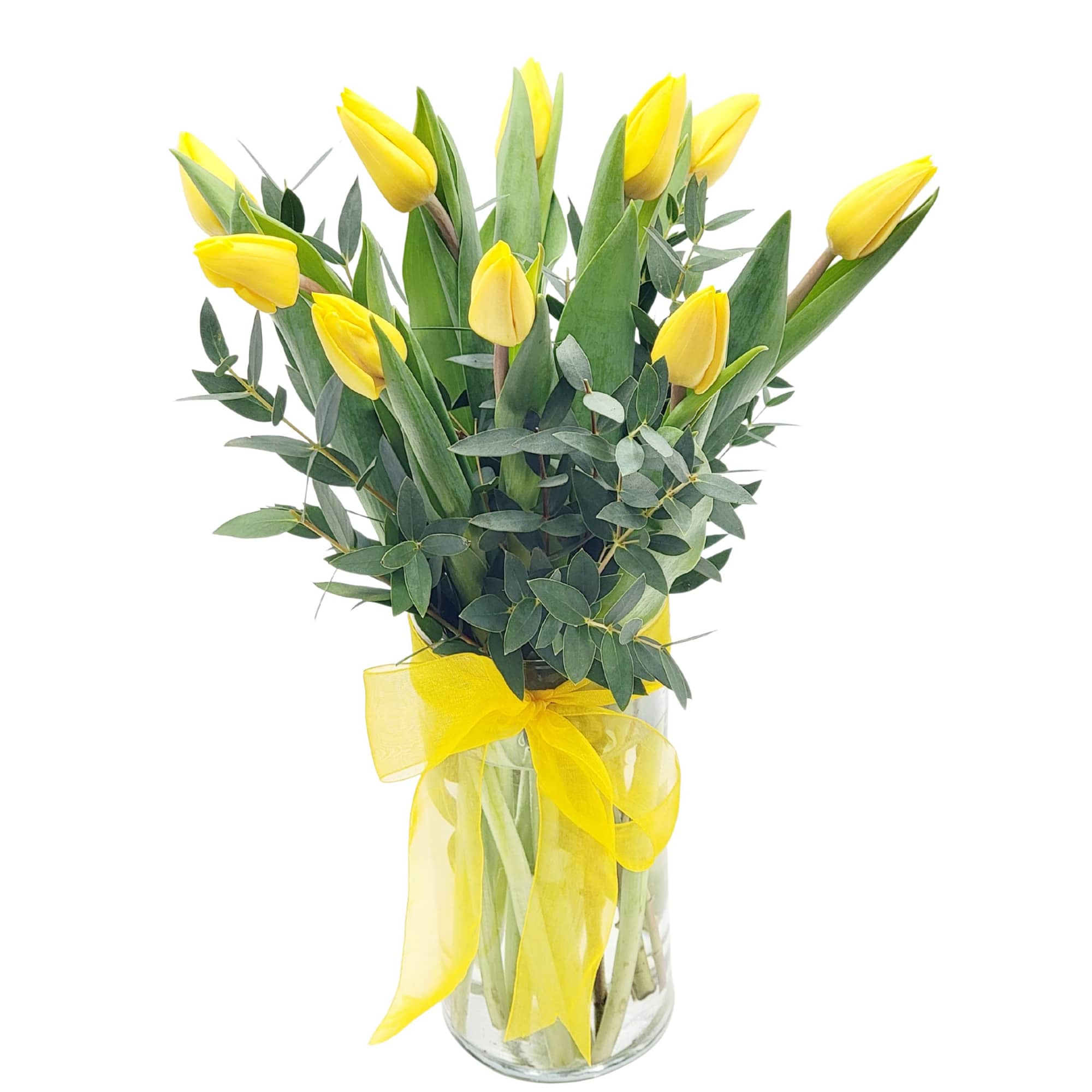 Yellow tulips in a clear glass vase with a yellow ribbon