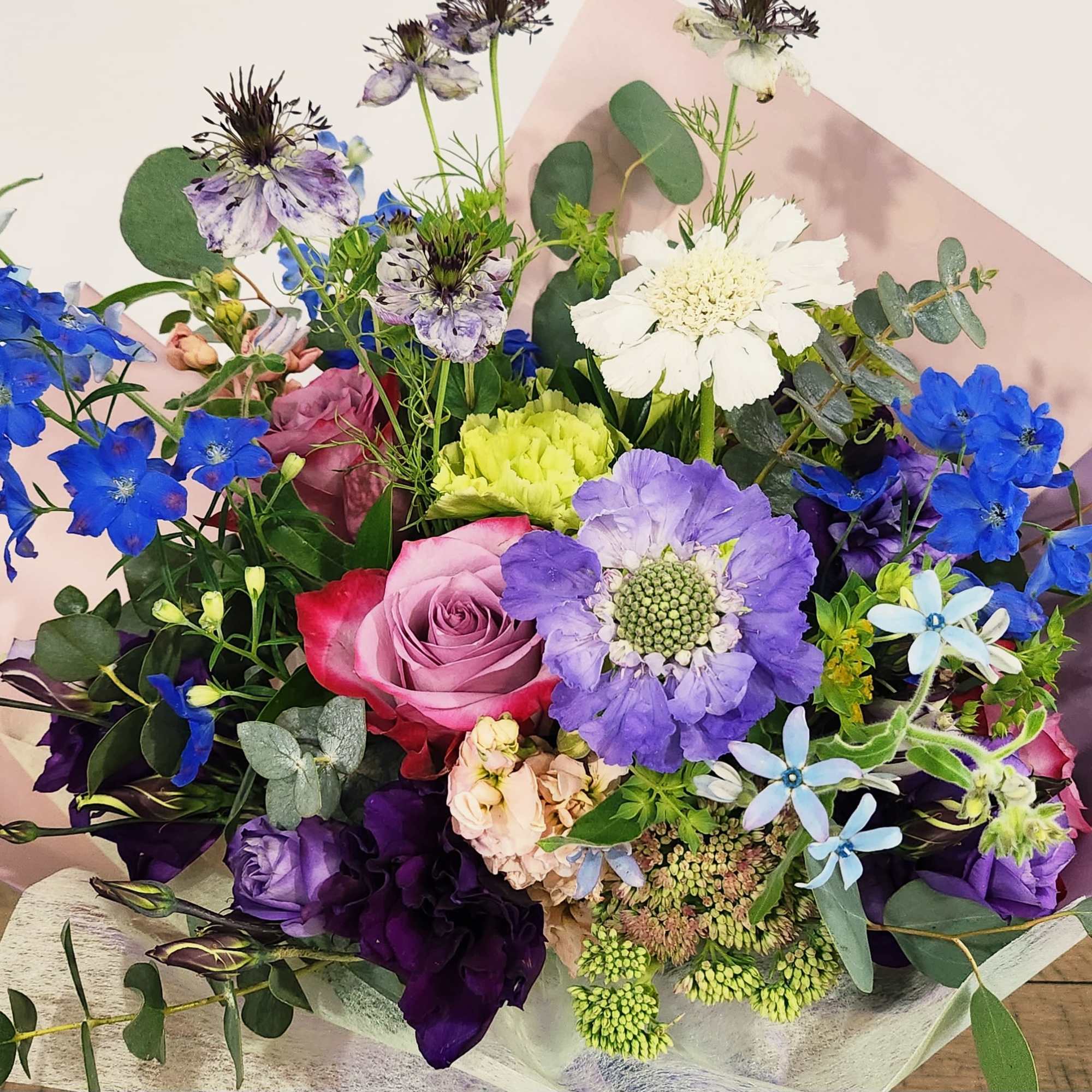 Mixed bouquet with blue, purple, pink, and white flowers