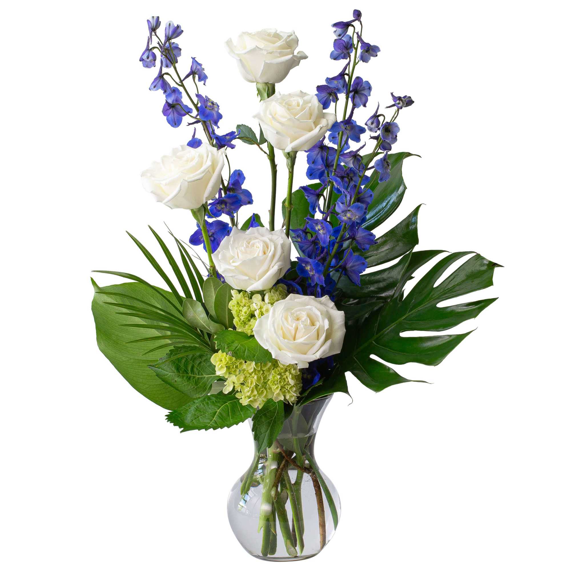 White roses and blue delphinium in a clear glass vase