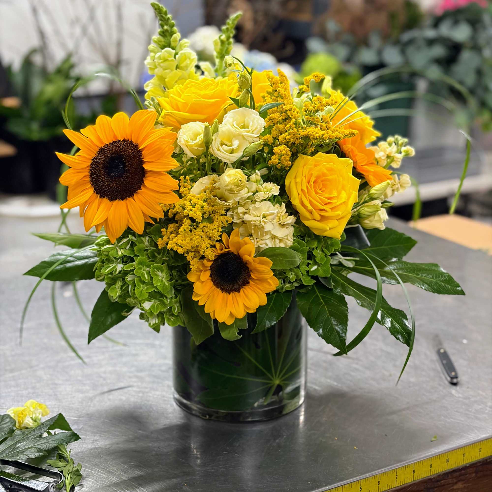 Sun-soaked and cheerful, this more traditional-style arrangement will brighten the home or