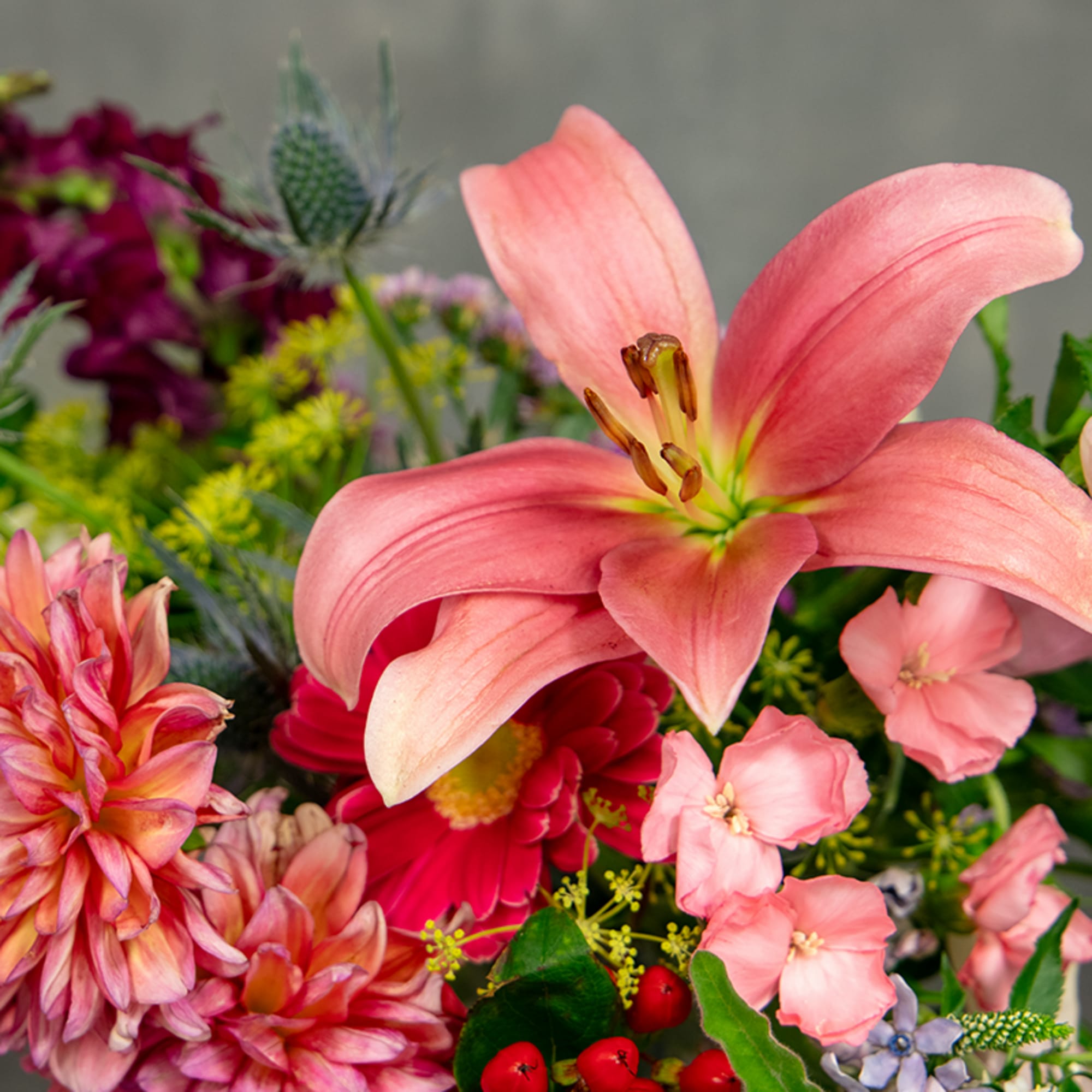 Pink lily and mixed flowers in a colorful bouquet