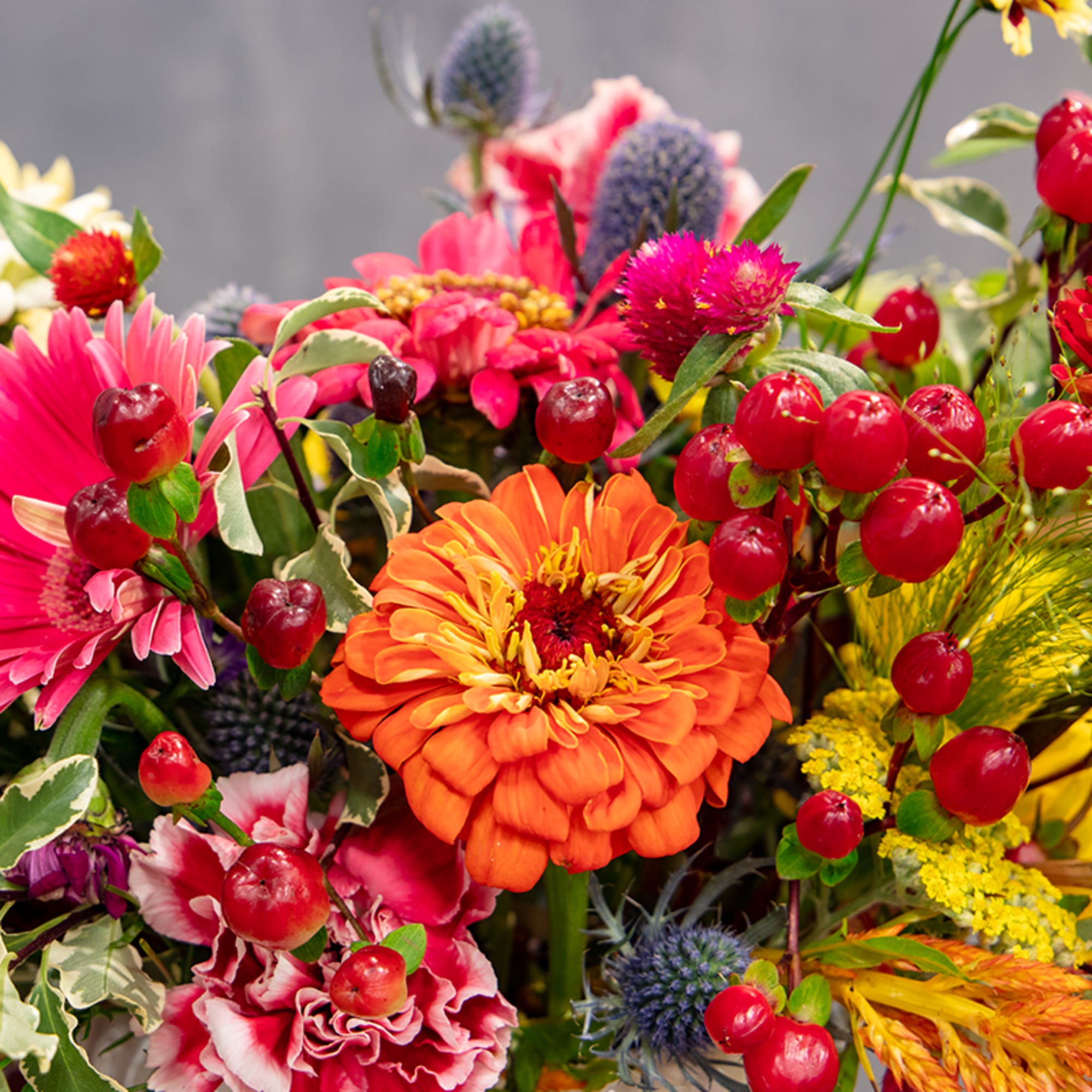 Bright mixed bouquet with orange and pink blooms in a vase