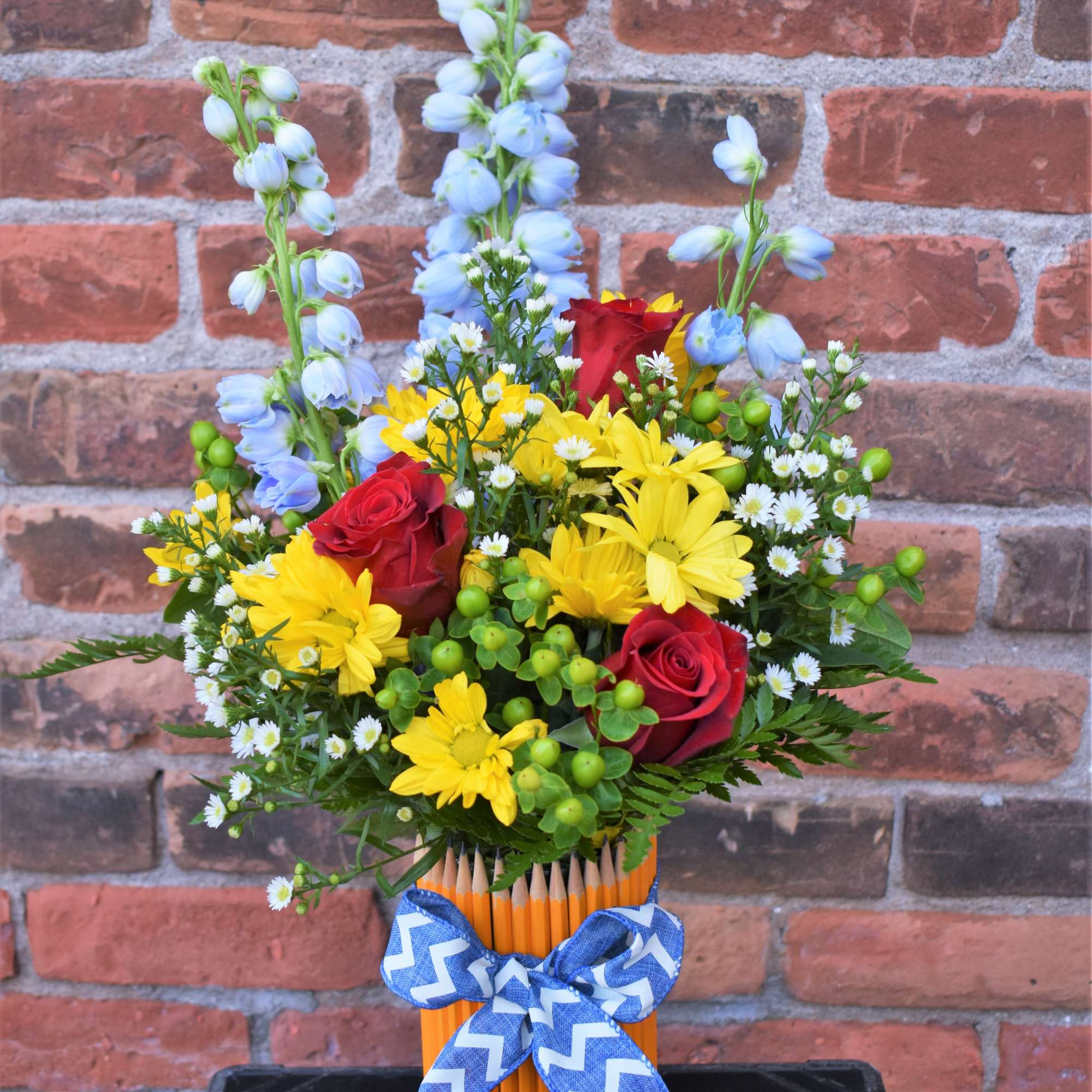 This colorful array of yellow daisies, red roses, asters, hypericum berries, blue, photo 2 of 2