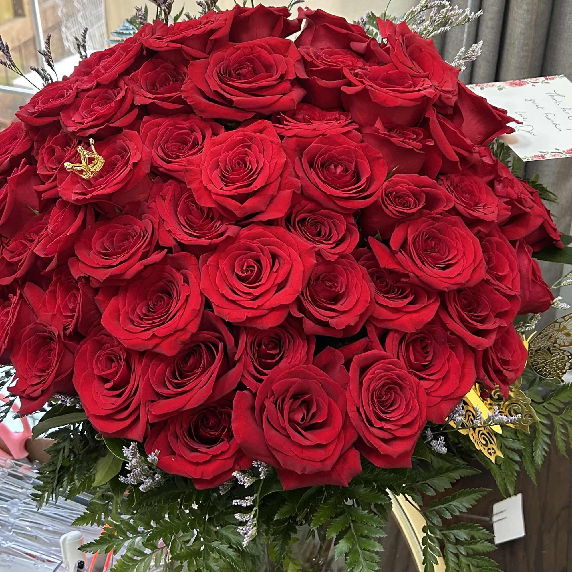 An impressive and chic display of fifty premium red roses, expertly arranged