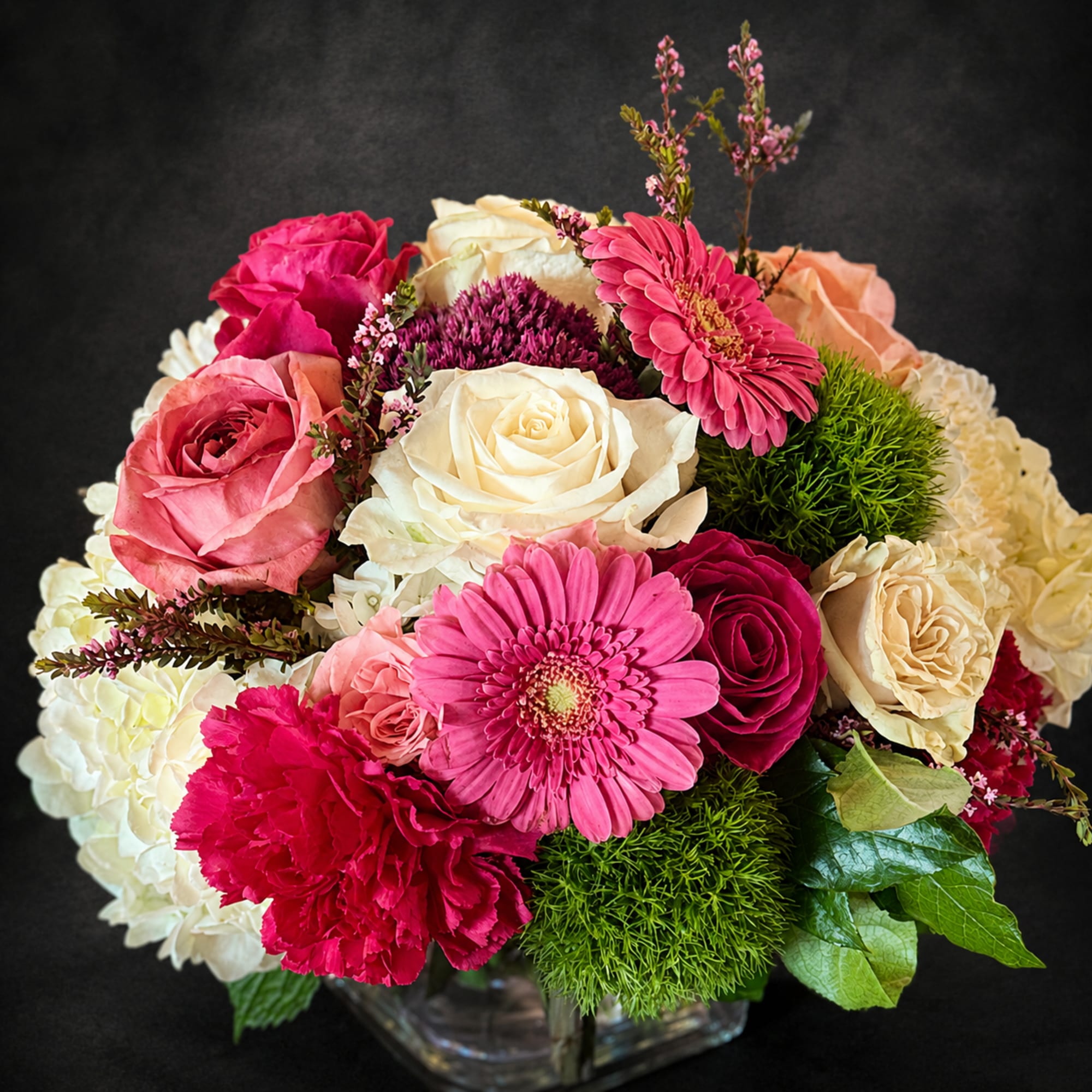 Soft blush and cream roses meet bright pink gerbera daisies and vivid