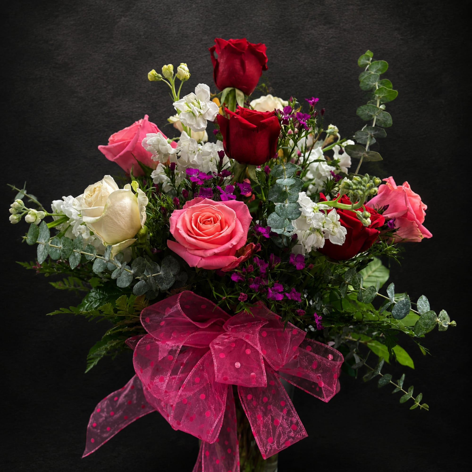 A lush bouquet of red, pink and white roses creates an immediate