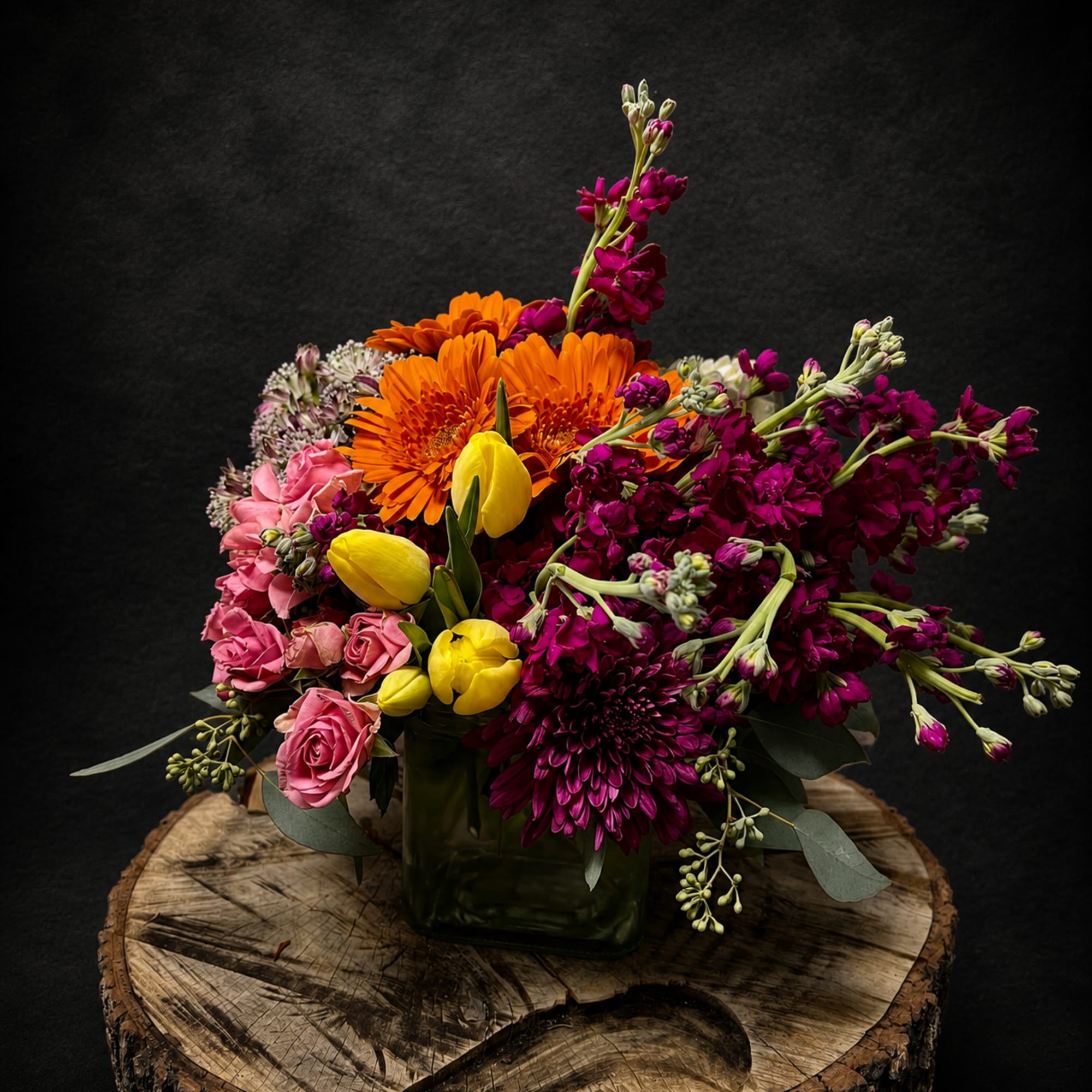 Bright, joyful colors make this mixed flower arrangement feel like a little