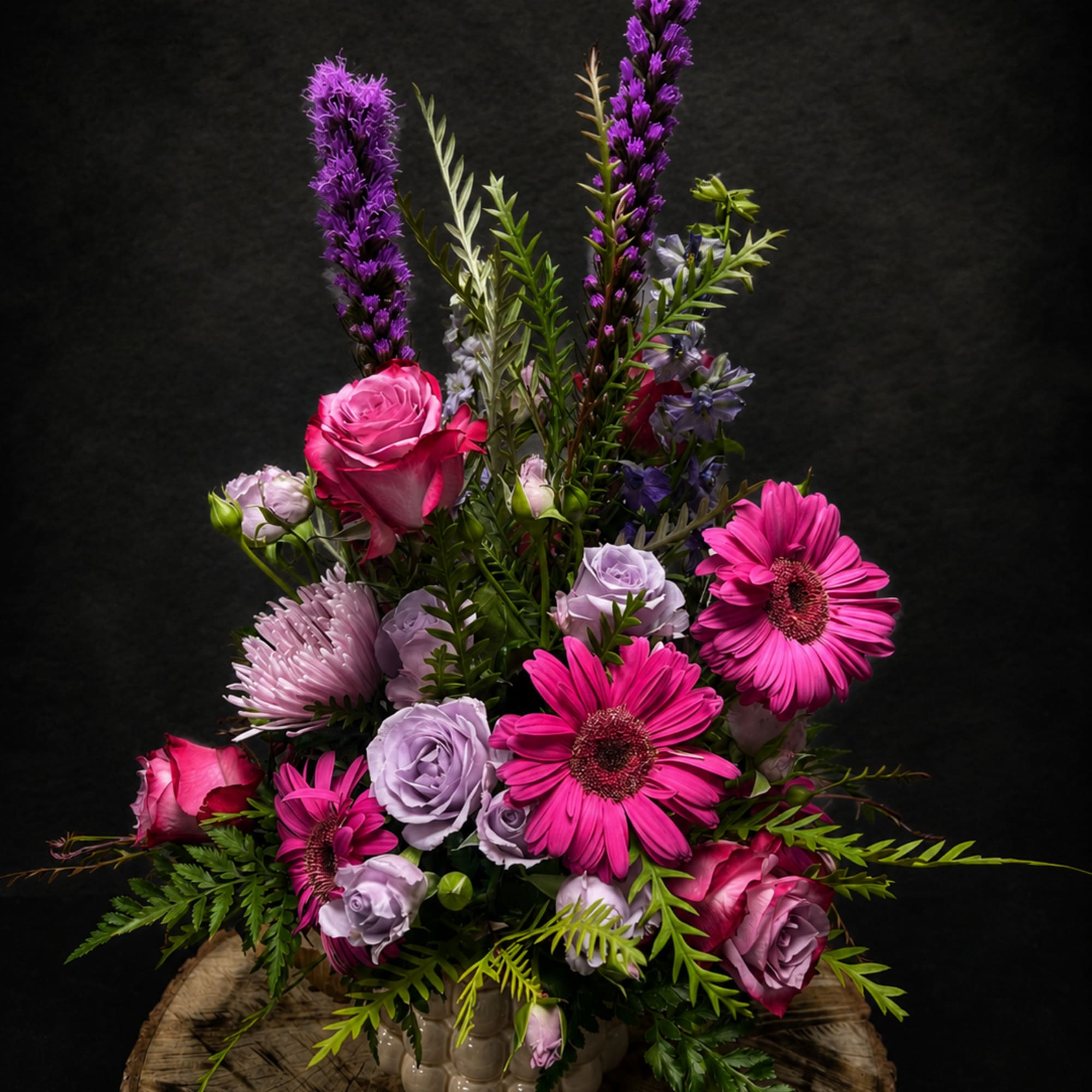 Bright pink gerbera daisies and roses meet soft lavender roses and pale