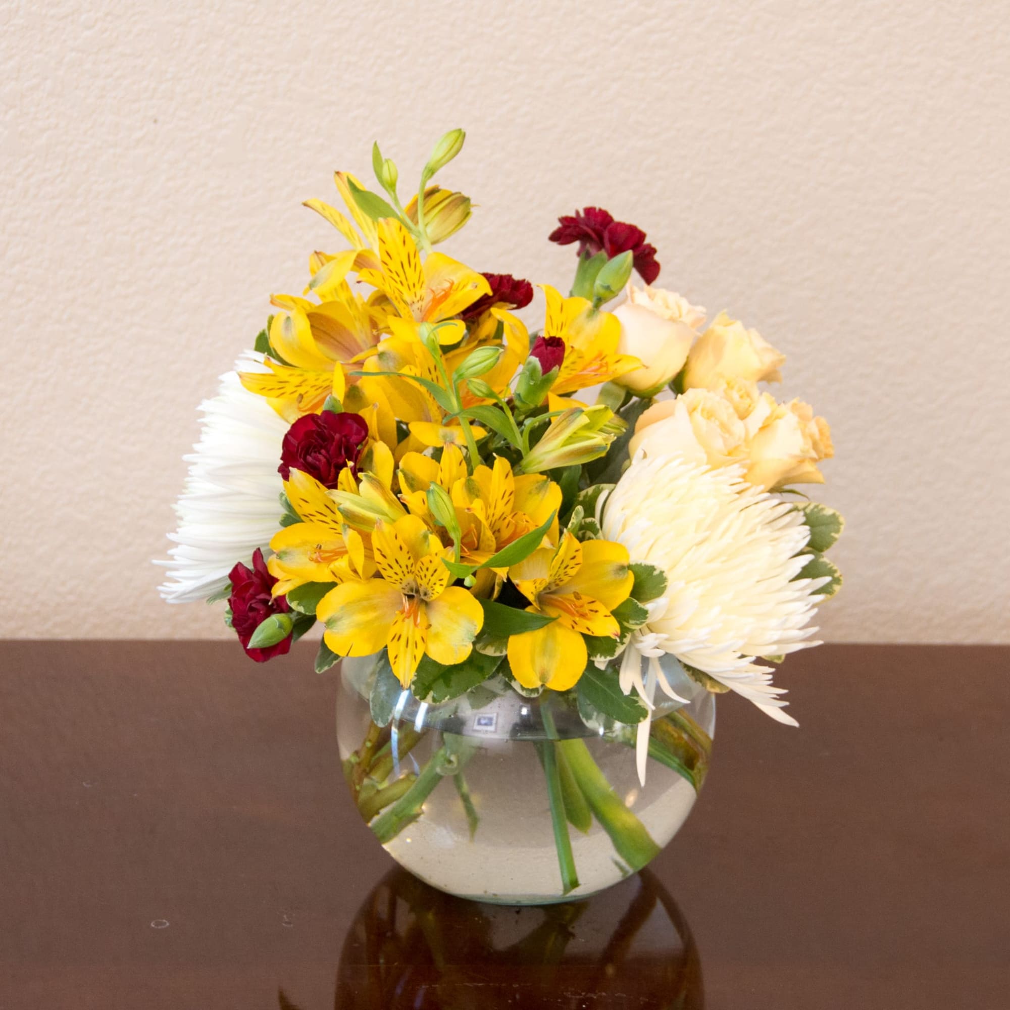 Cute little arrangement with bright colored flowers. Nice and compact for a