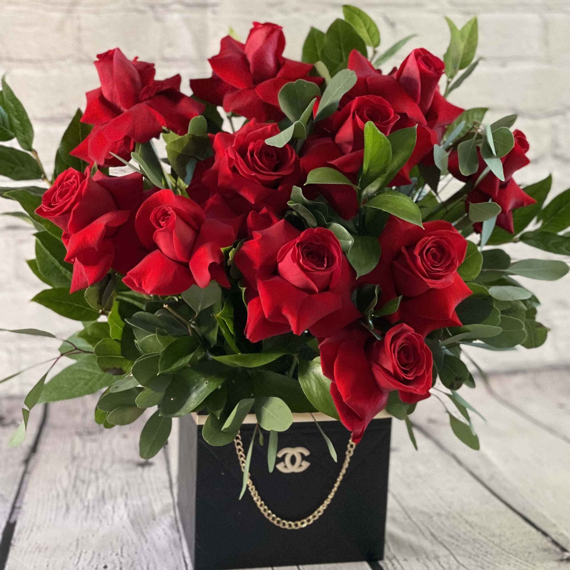 Bouquet of red roses in a black gift box