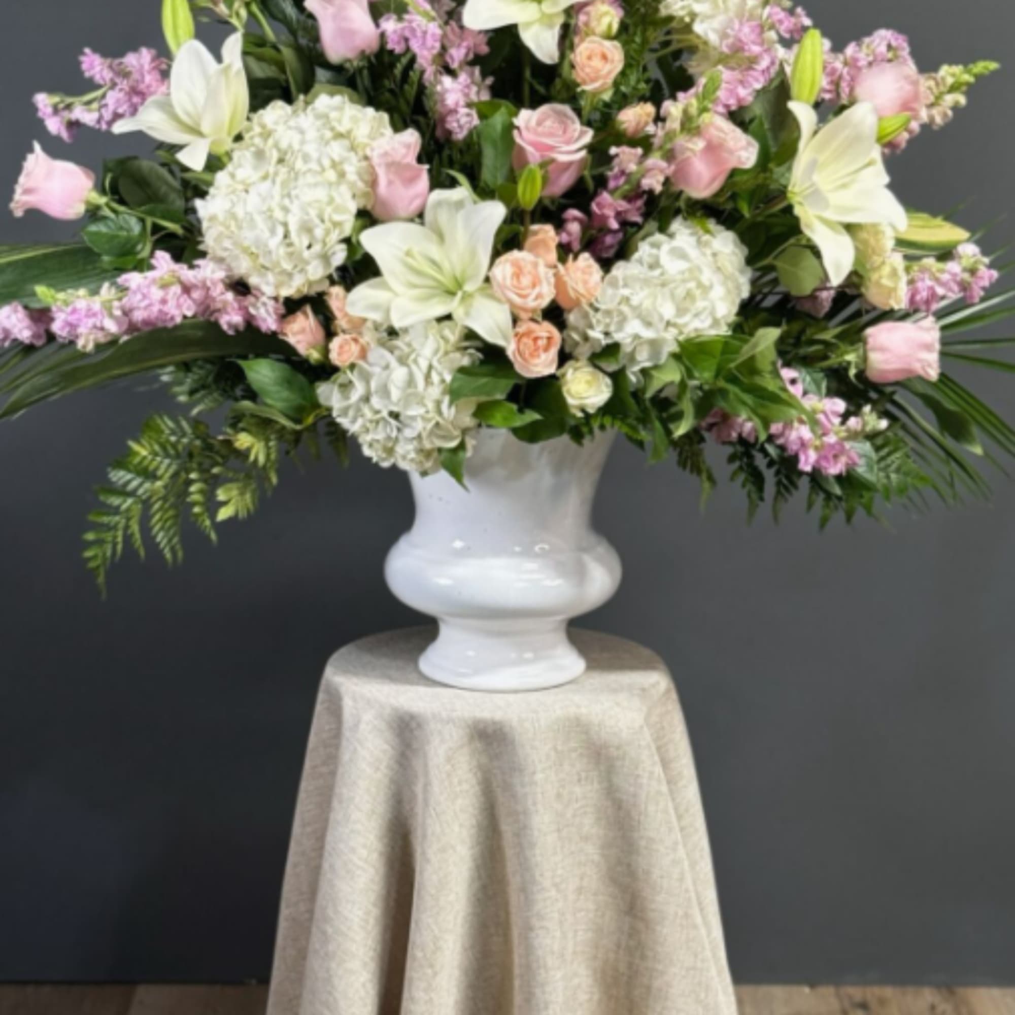 The Peaceful Wishes Sympathy Basket is a graceful and heartfelt floral tribute