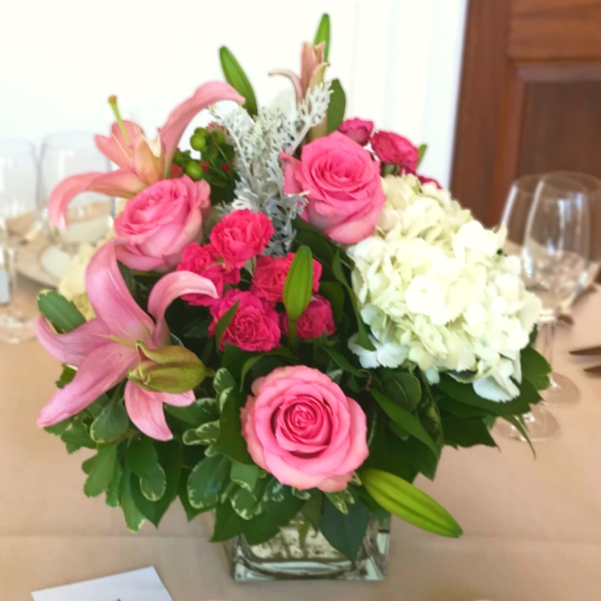 Pink roses and lilies with white hydrangea in a glass vase