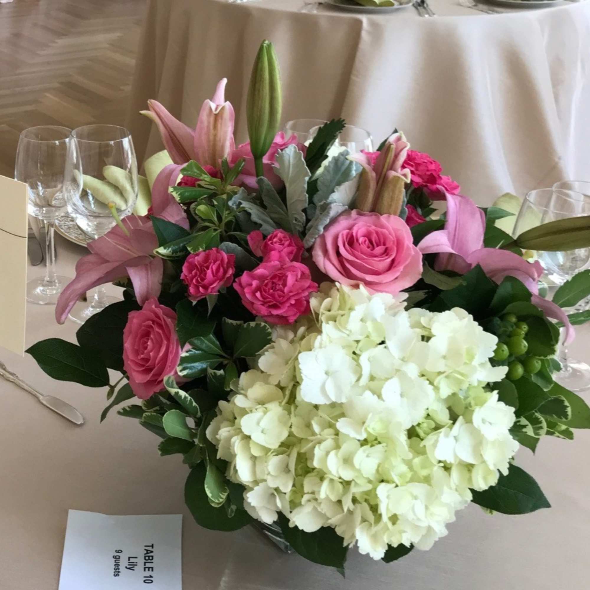 Pink lilies and roses with white hydrangeas in a low table centerpiece