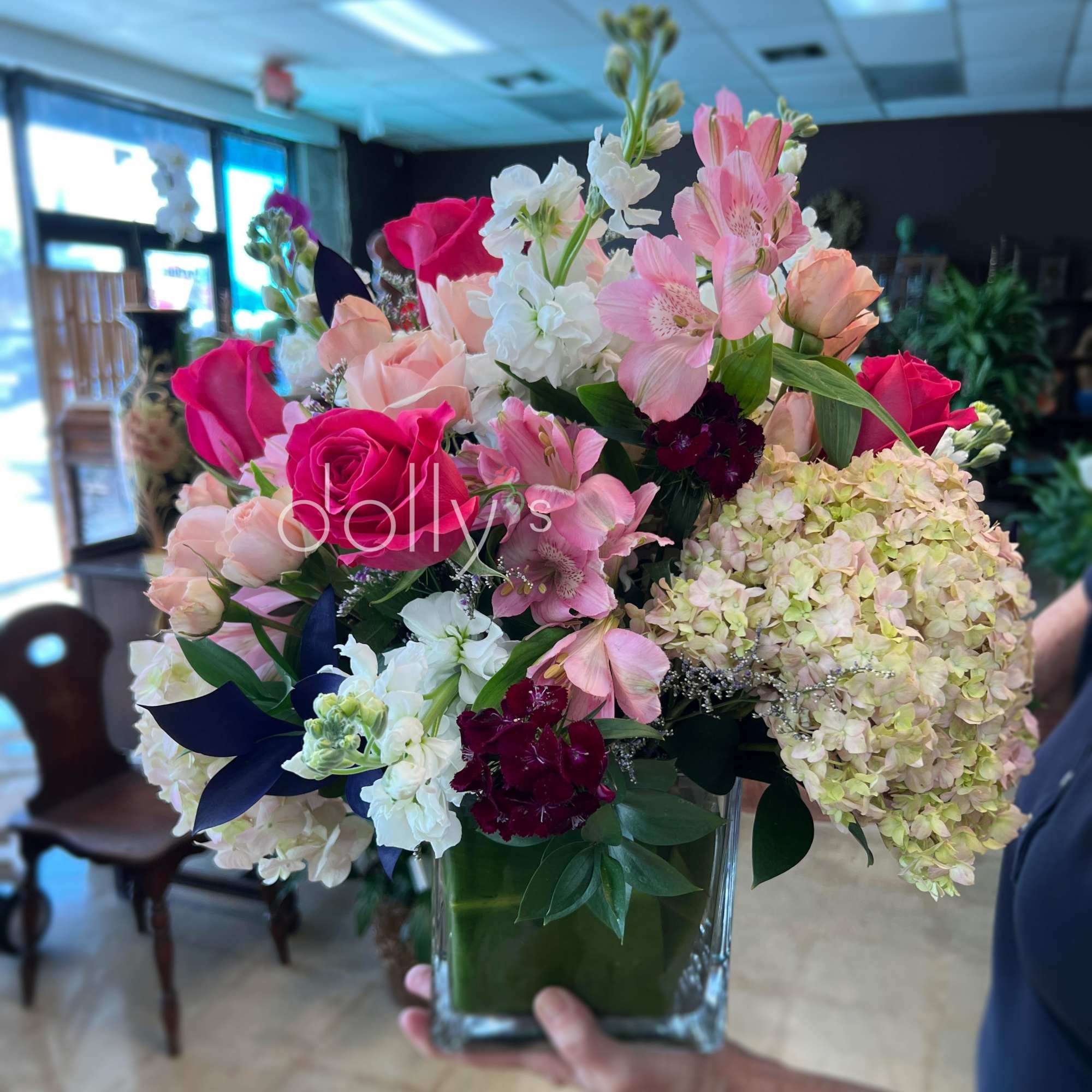 A bright hot-pink rose anchors this lively flower arrangement, surrounded by cloud-like, photo 3 of 3