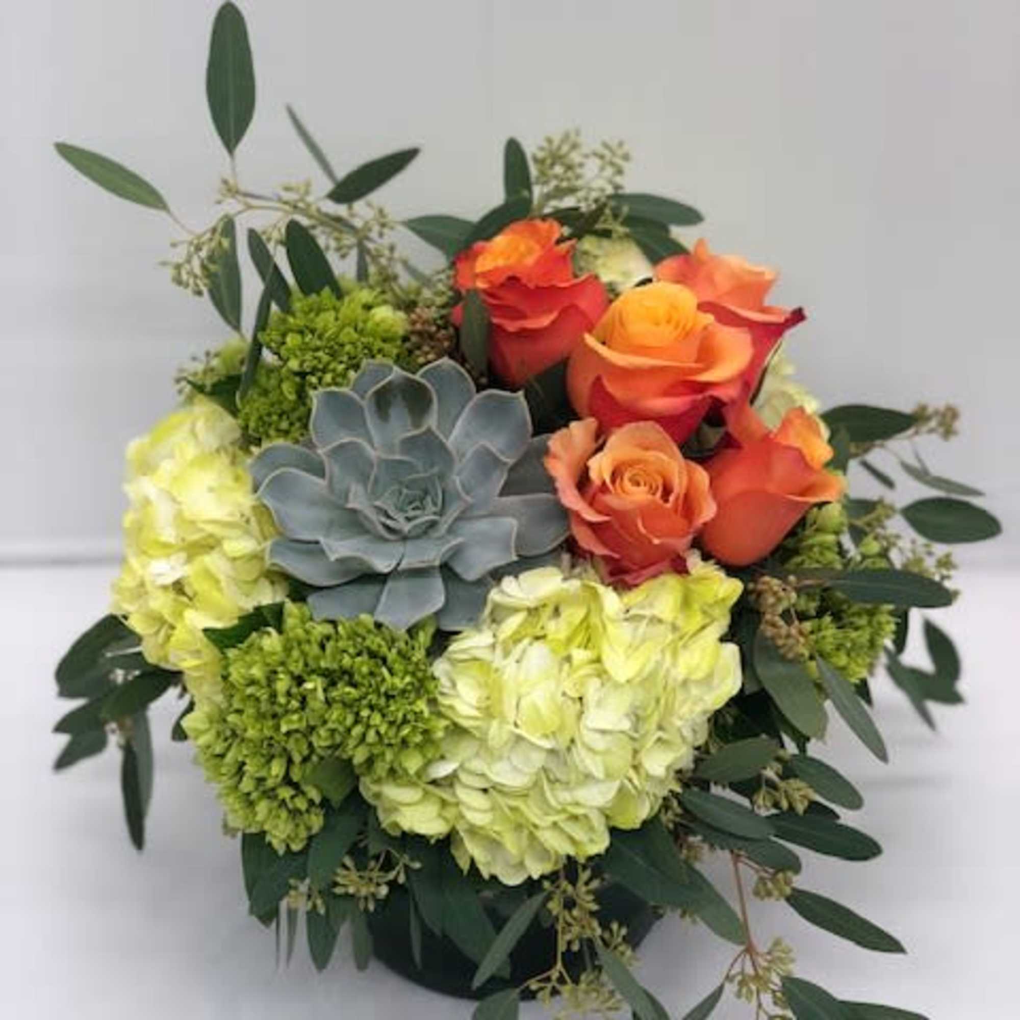 Bouquet of orange roses, hydrangeas, and a blue succulent
