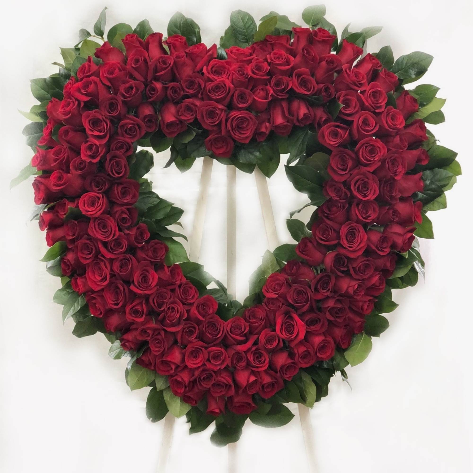 Heart-shaped wreath of red roses on a stand, photo 2 of 2