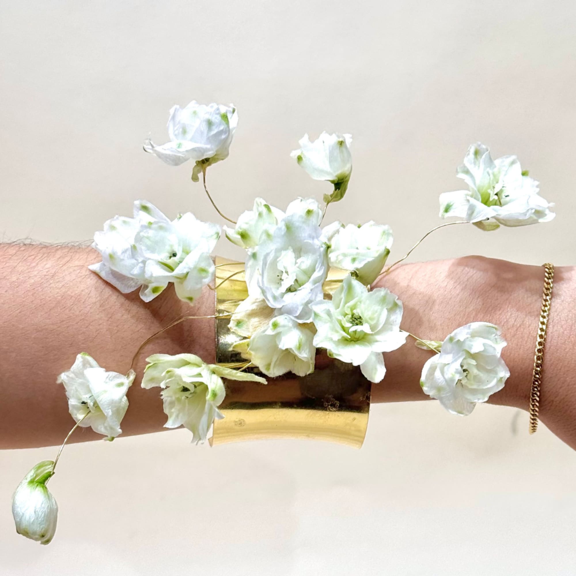 A luxurious wire-frame cuff adorned exclusively with premium blooms, creating a floral