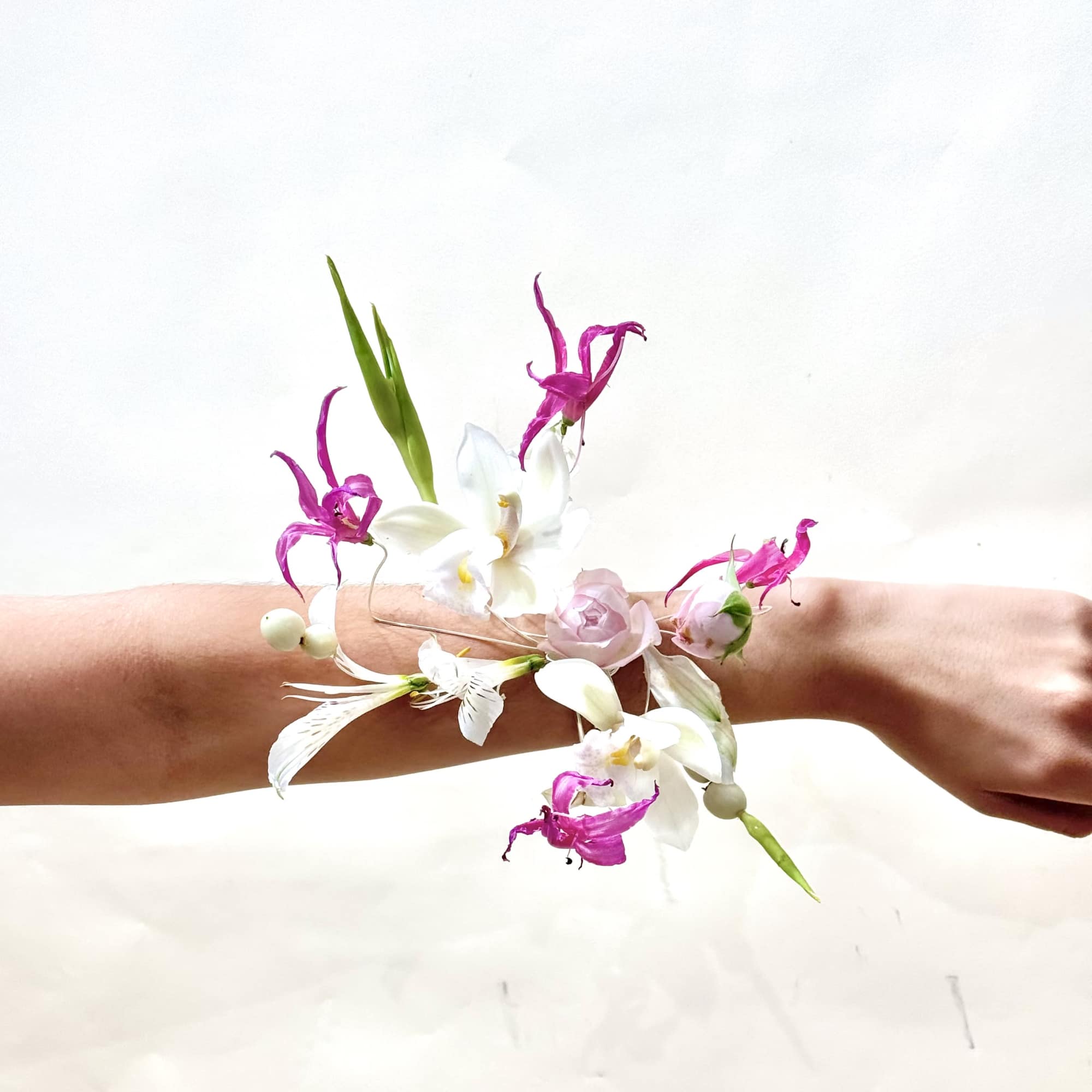 A luxurious wire-frame cuff adorned exclusively with premium blooms, creating a floral